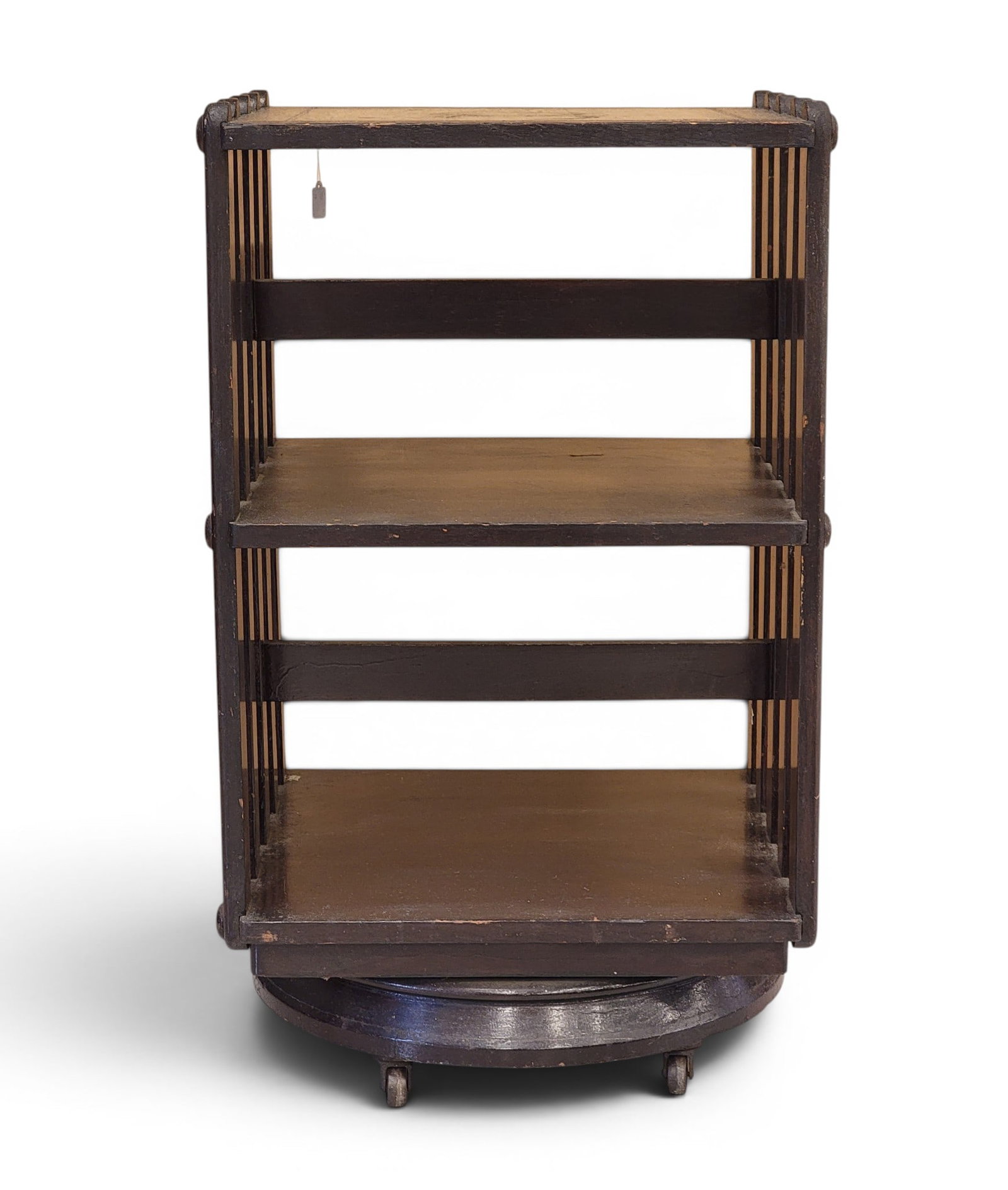 REVOLVING BOOKCASE: American, late 19th-early 20th century. Slated sides and original mahogany finish. 31.75" high, 17.75" wide, 19.5" deep. This bookcase is similar to the patented revolving bookcases by John Danner of