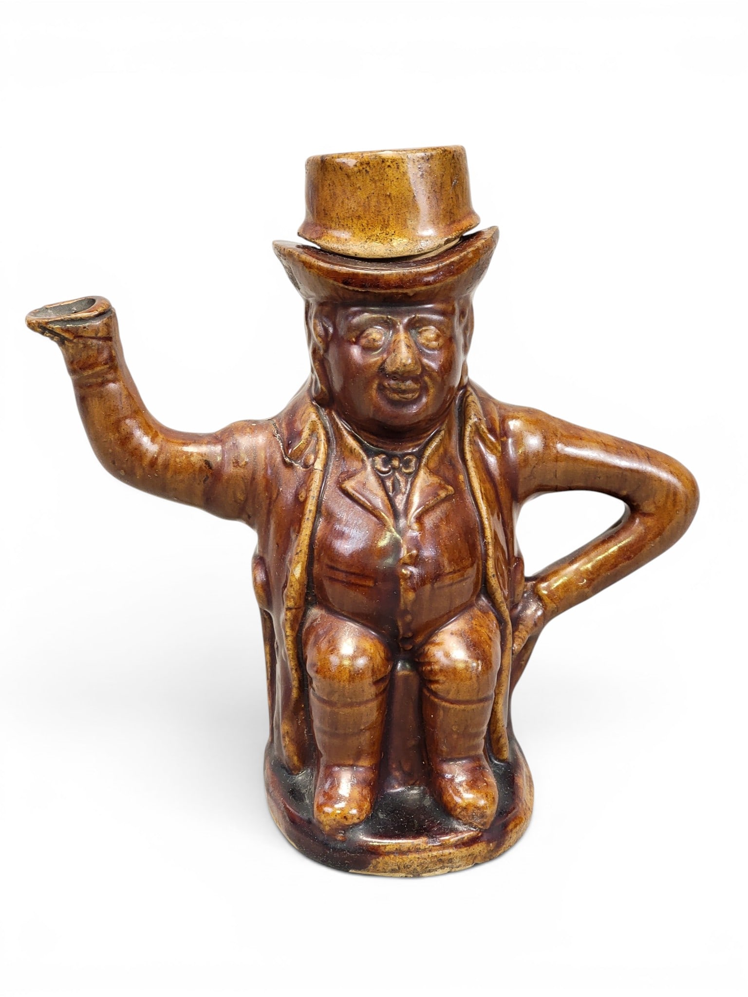 COLLECTION OF ROCKINGHAM WARES: American, mid-19th century. Includes a figural teapot (man in a hat), 8.25" high; a pitcher, 8.25" high; four bowls, 6.25" to 10.5" diameter; and a covered bowl, 6.75" diameter. Provenance: a Pennsylv