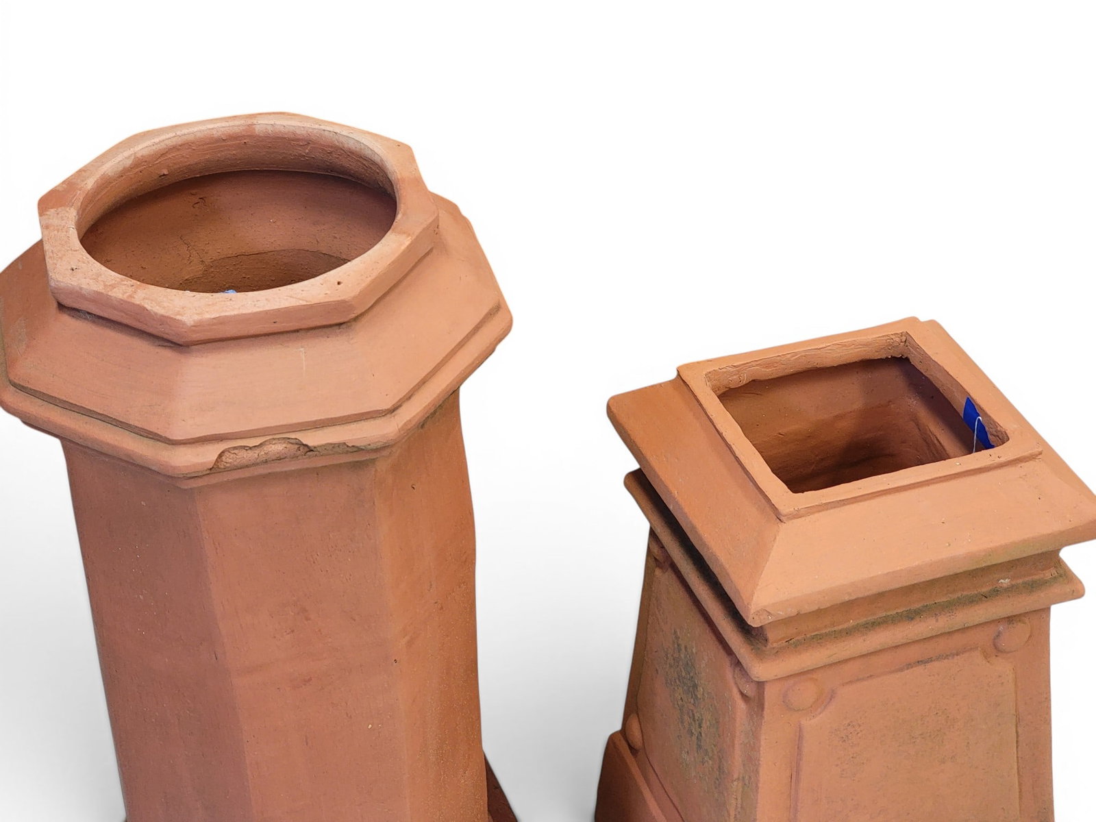 TWO TERRA COTTA CHIMNEY CAPS: One is marked for Fred Mashman, Kingsgrove, Sydney, Australia, 20th century. Of typical forms. 31.5" and 21.5" high. Provenance: a Pennsylvania collection. NOTE: We are happy to answer questions and t