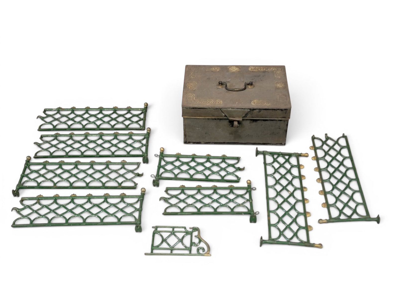 WRITING BOX AND CHRISTMAS TREE FENCE: American, 19th century. Includes a tin traveling writing box, with fitted interior, 5" high, 10.5" wide, 7.5" deep; together with a cast-iron Christmas tree fence in original green and gold paint,