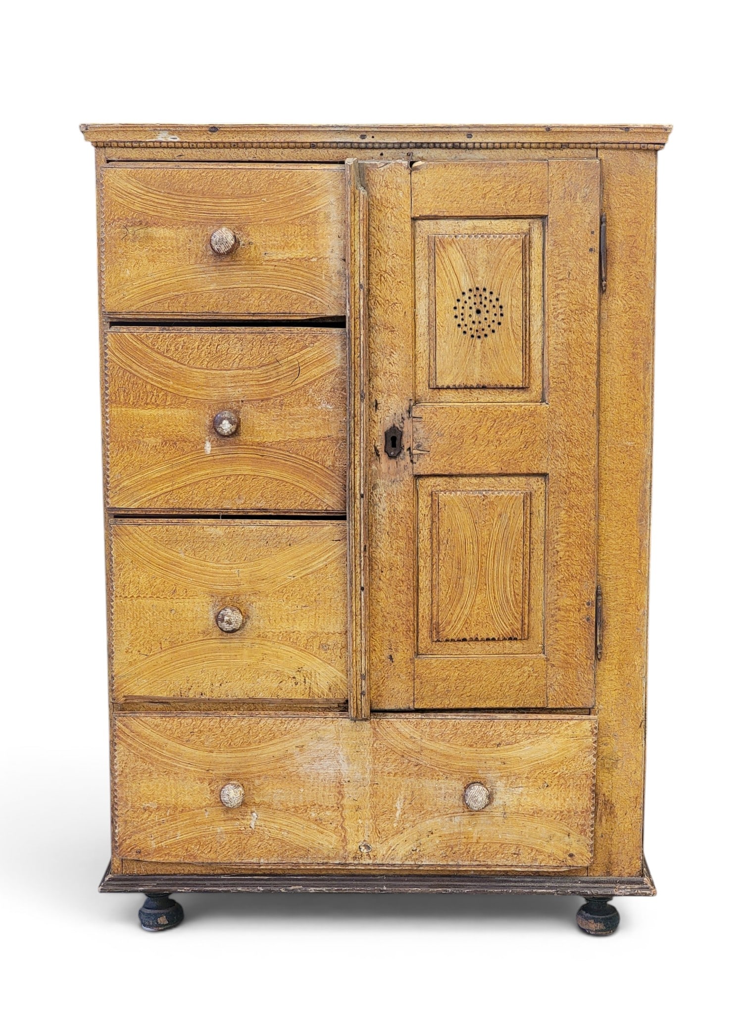 DECORATED FOOD CUPBOARD: American, mid-19th century, pine. With three drawers and a door over a long drawer, the door with holes indicating that it stored baked goods. Retains early/original grain painted decoration. 59"