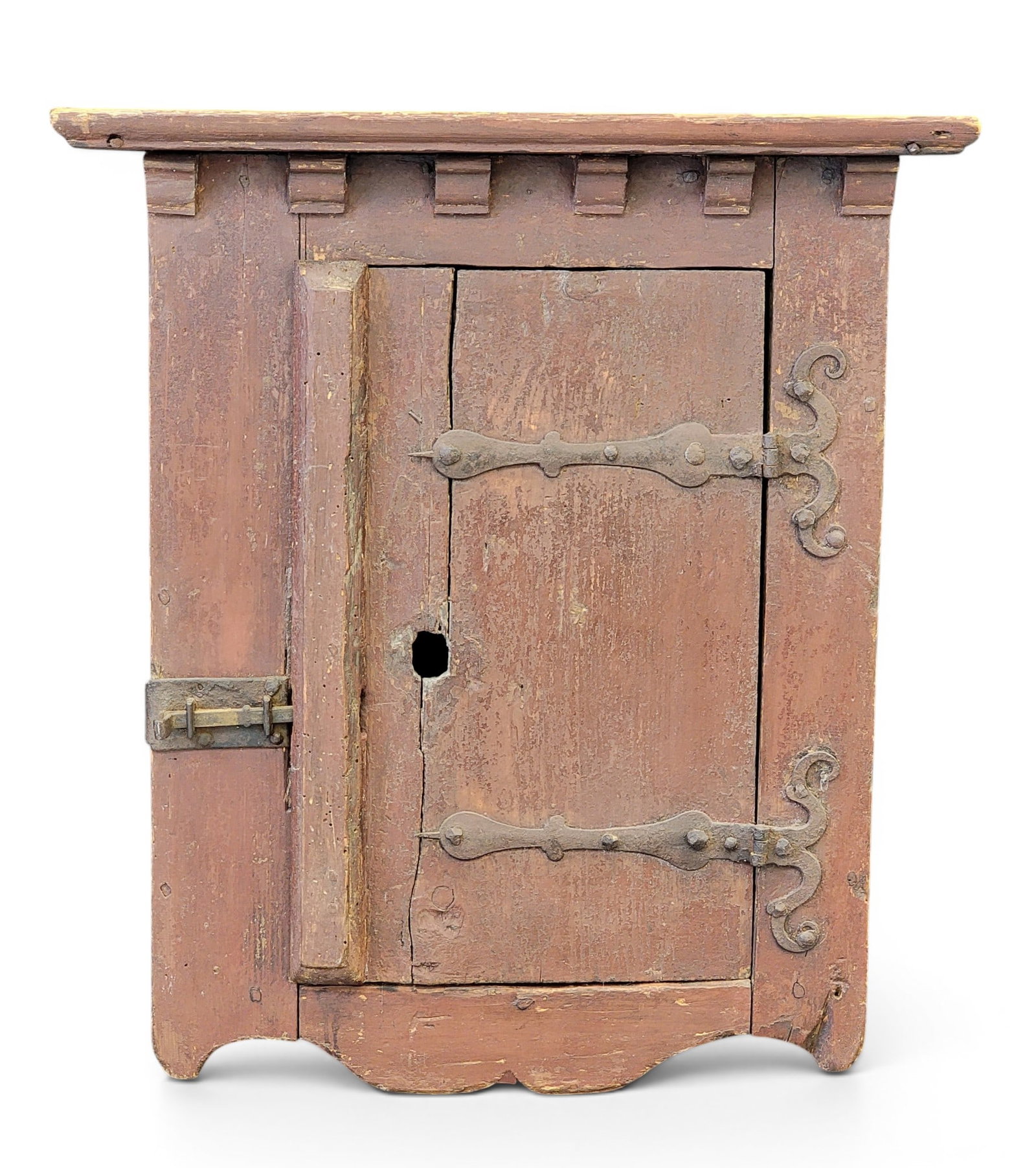 DIMINUTIVE CUPBOARD: American or European, 19th century, pine. Small size and with exceptional ironwork, and old red paint. 22" high, 20.5" wide, 15.5" deep. Provenance: an Ohio collection. NOTE: We are happy to answer