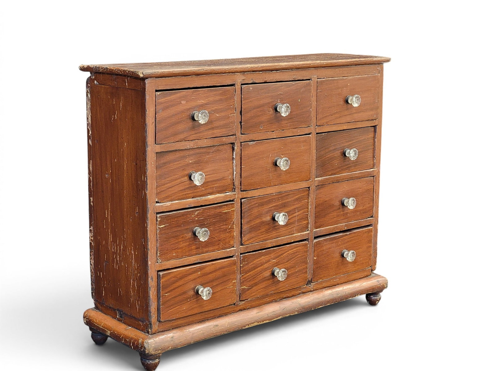 APOTHECARY OR SEED CHEST: American, mid-19th century, poplar. Twelve drawers, turned feet, and its original grain-painted decoration. 18" high, 20.5" wide, 7.5" deep. Provenance: an Ohio collection. NOTE: We are happy to answe