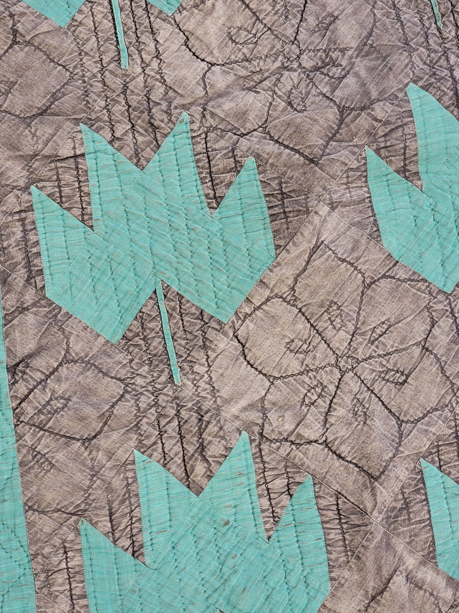 AMISH CRIB QUILT: Possibly Iowa, 20th century. Green leaves against black ground and with a blue border. 40" by 34". Provenance: a Wisconsin collection. NOTE: We are happy to answer questions and take additional photos