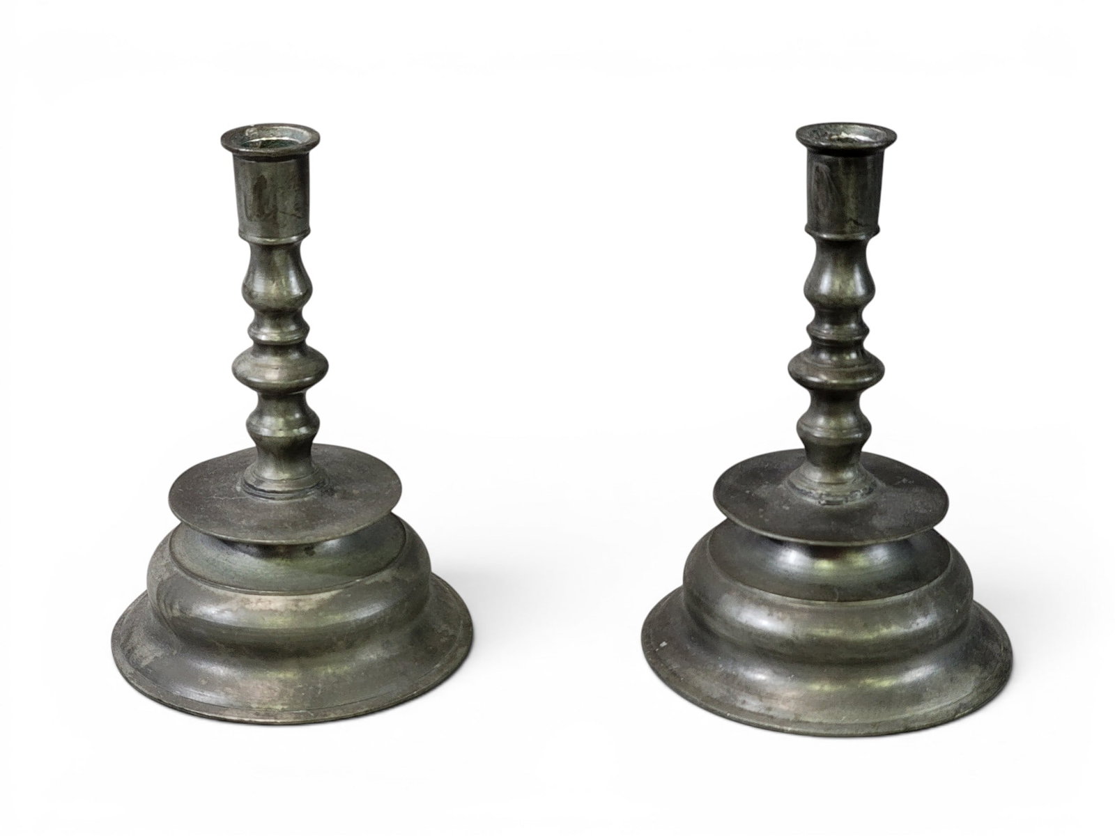 PAIR OF PEWTER CAPSTAN CANDLESTICKS: European, 18th century. Of typical form. 6.5" high. Provenance: an Ohio collection. NOTE: We are happy to answer questions and take additional photos of lots prior to the auction (the sooner
