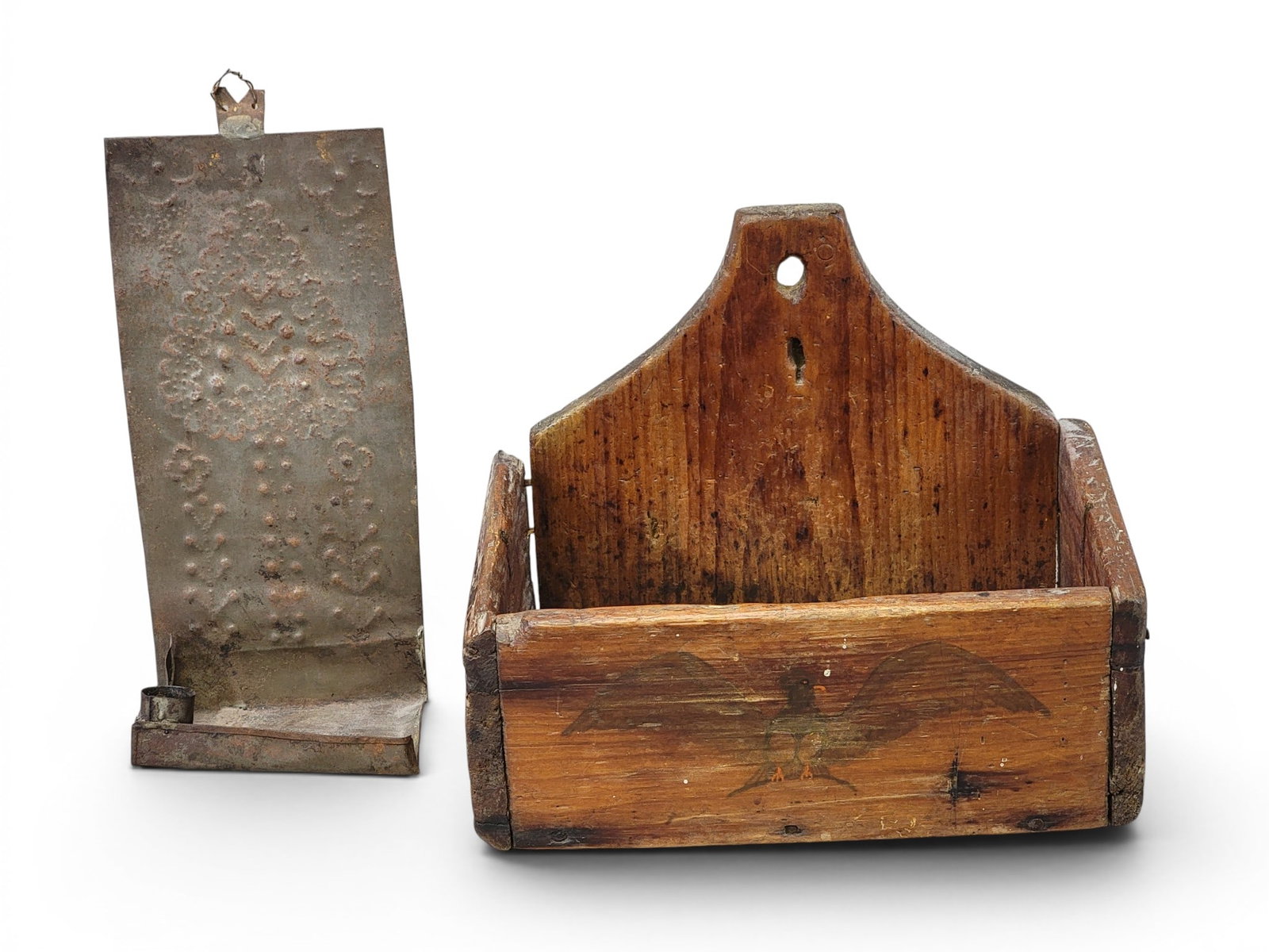 HANGING BOX AND TIN SCONCE: American, 19th century. Includes a square-nailed wall box with a painted bird on the front, 11.5" wide; together with punched tin sconce with floral decoration, 12" high. Provenance: an Ohio