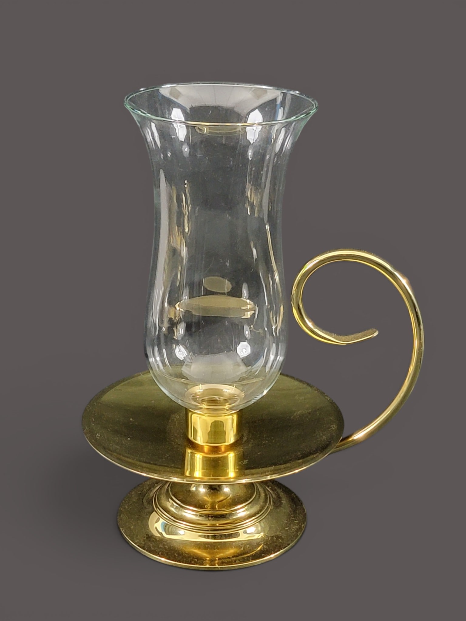 COLLECTION OF BRASS ITEMS: 19th-20th century. Includes a pair and single candlesticks, 8.75" and 10" high; together with a scoop, 11" long; a chestnut roaster, 23" long; and a Baldwin reproduction candleholder with chimney, 14"