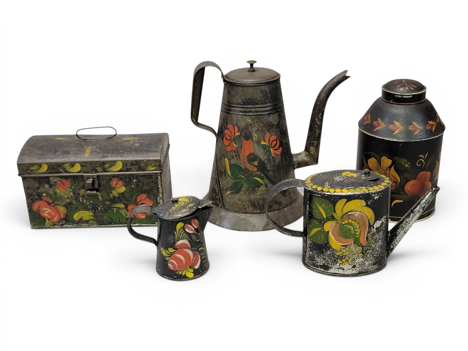 COLLECTION OF TOLEWARE: American, 2nd quarter-19th century, tin-plated sheet iron. All with floral decoration on a black ground. Includes a coffee pot, teapot, cream pitcher, tea canister, and document box. Coffee pot is
