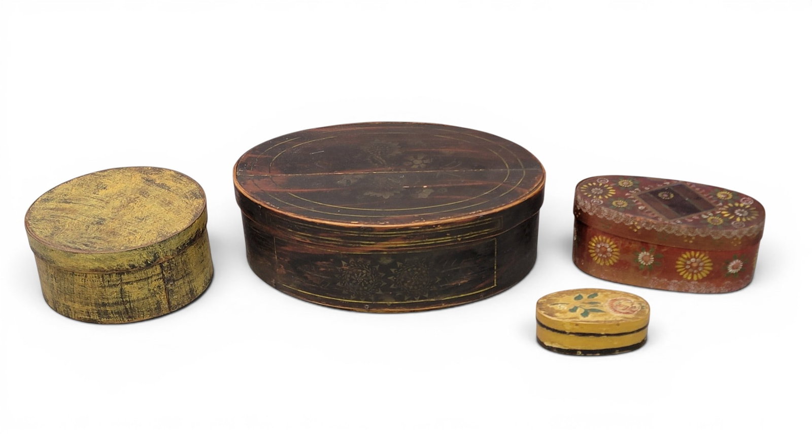 FOUR DECORATED BENTWOOD BOXES: American and European, 19th century. Includes an oblong box with original stenciled decoration, 14" long; together with a round pantry box in yellow paint, 7.75" diameter; an oblong box with original