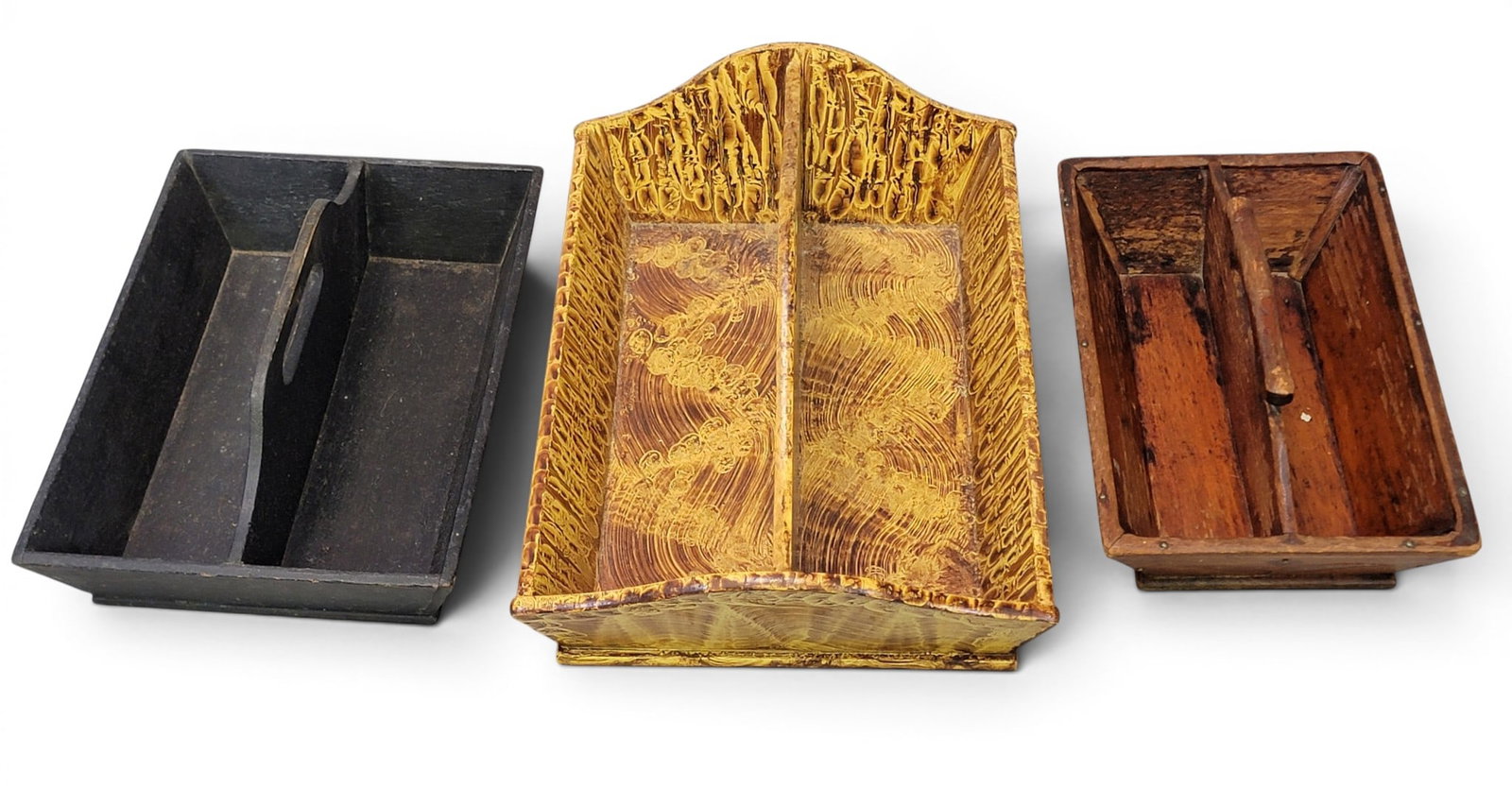 THREE CUTLERY TRAYS: American, 19th-20th century. Includes a tray with inlaid hearts and leaves, 12.5" long; together with a tray with old black paint, 13.25" long; and a contemporary paint-decorated tray, 17.25" long.