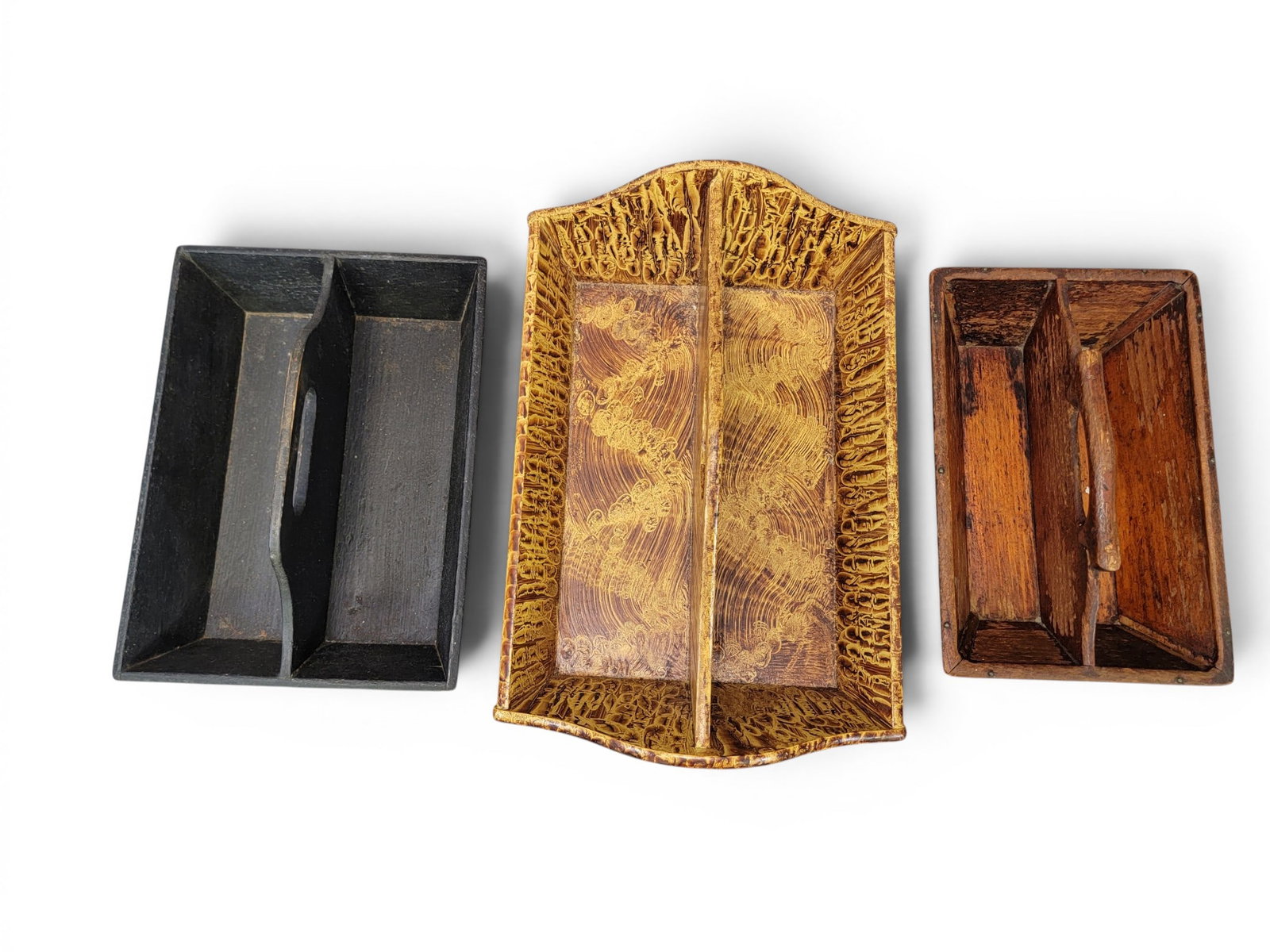 THREE CUTLERY TRAYS: American, 19th-20th century. Includes a tray with inlaid hearts and leaves, 12.5" long; together with a tray with old black paint, 13.25" long; and a contemporary paint-decorated tray, 17.25" long.
