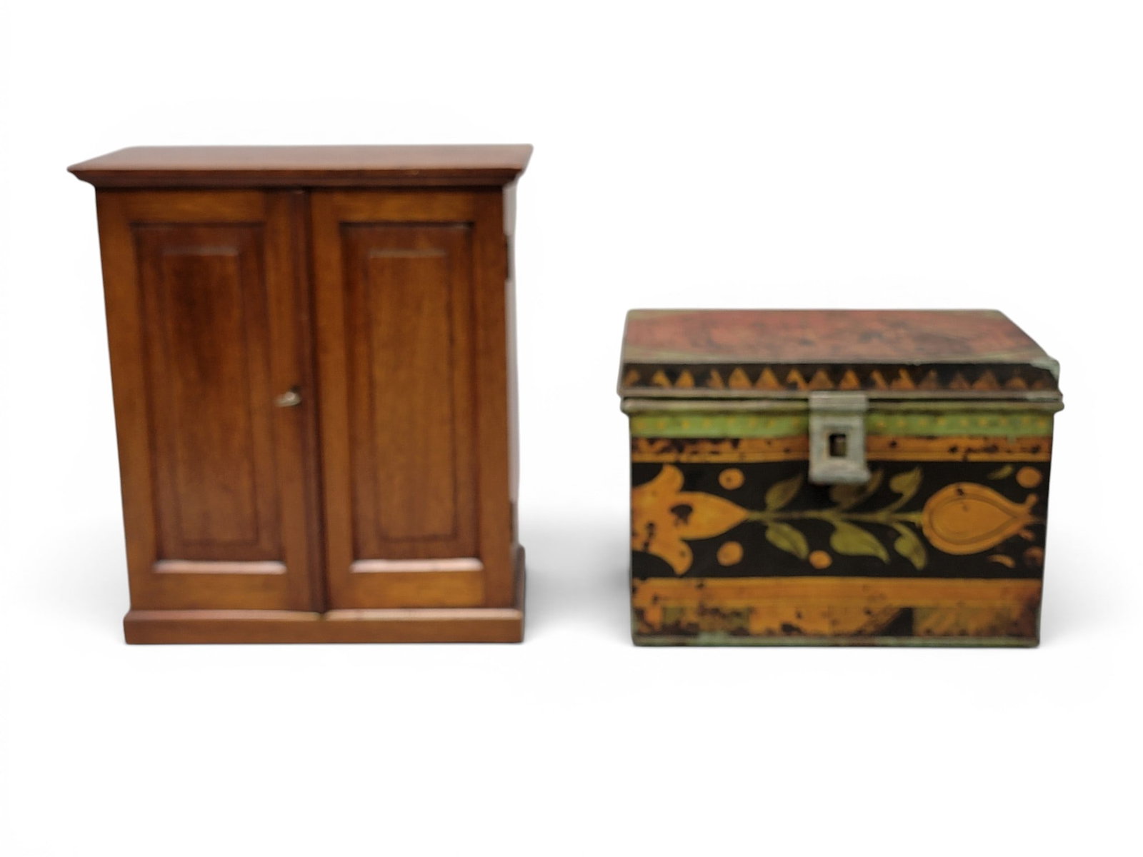 MINIATURE WARDROBE AND TIN BOX: 20th century. Includes a miniature mahogany wardrobe with paneled doors and interior drawers, 13.25" high; together with a tin box with tulips and a dancing scene, 11.5" long. Provenance: from the