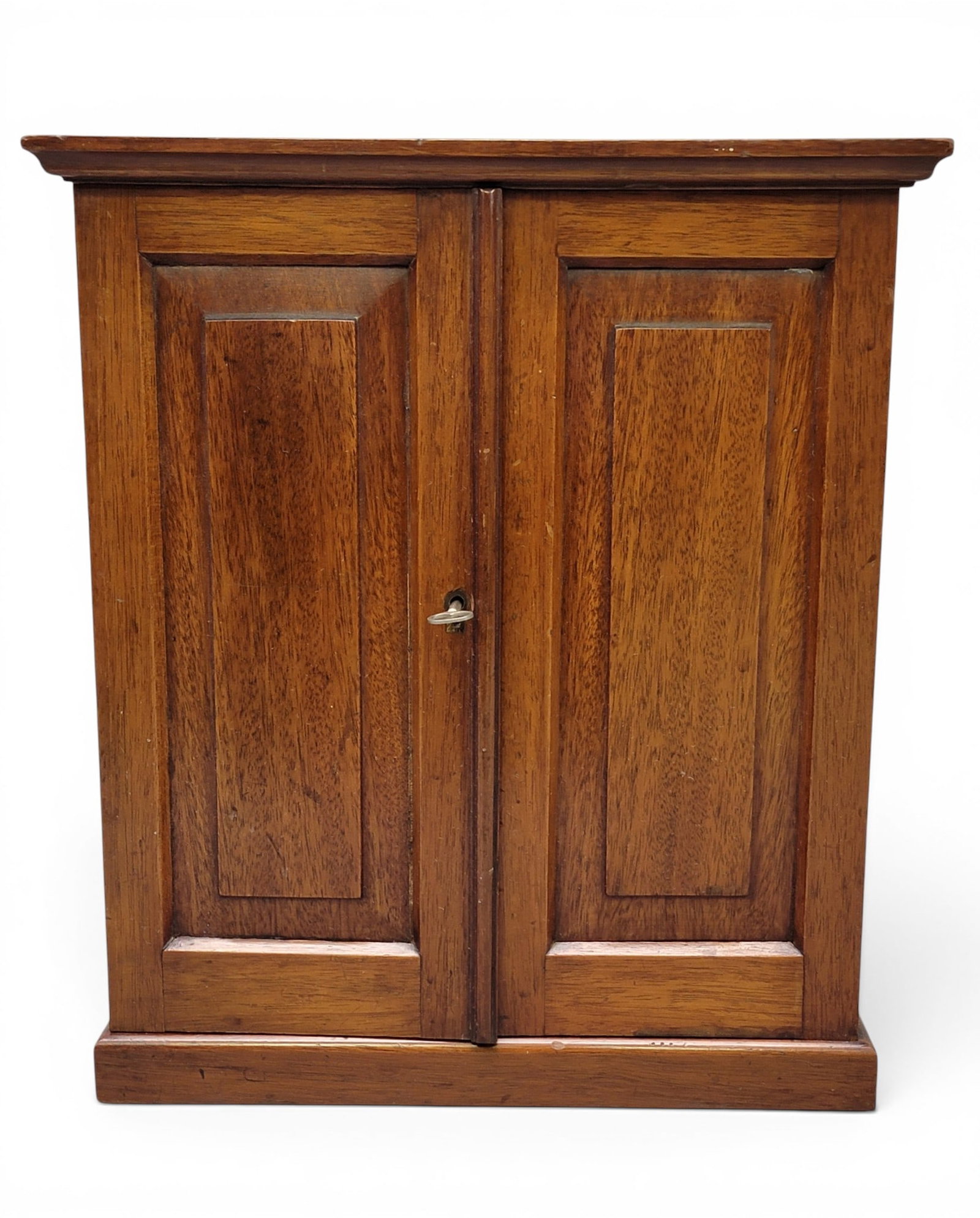 MINIATURE WARDROBE AND TIN BOX: 20th century. Includes a miniature mahogany wardrobe with paneled doors and interior drawers, 13.25" high; together with a tin box with tulips and a dancing scene, 11.5" long. Provenance: from the