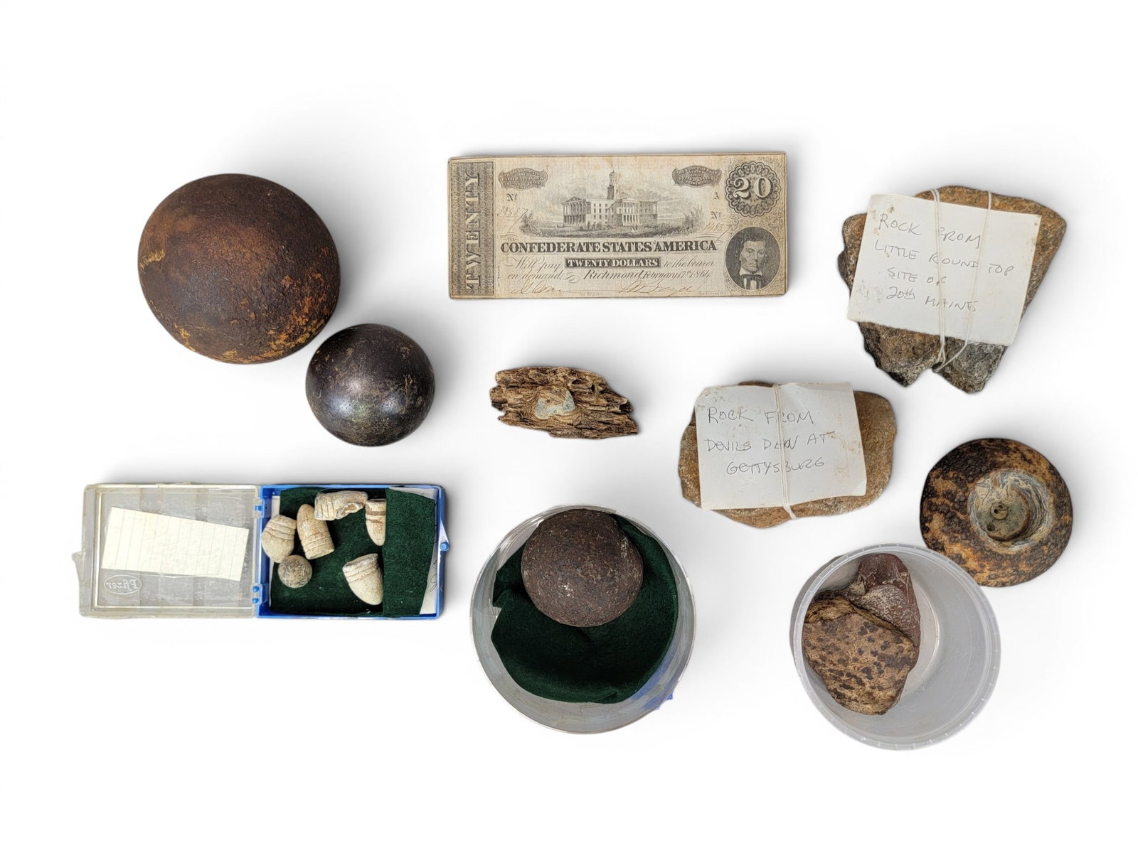 COLLECTION OF CIVIL WAR RELICS: Includes a $20 Confederate note; together with a collection of rocks and munitions, the latter all with notes indicating they were mostly collected at Gettysburg, with one 3" ball found on Buddington'