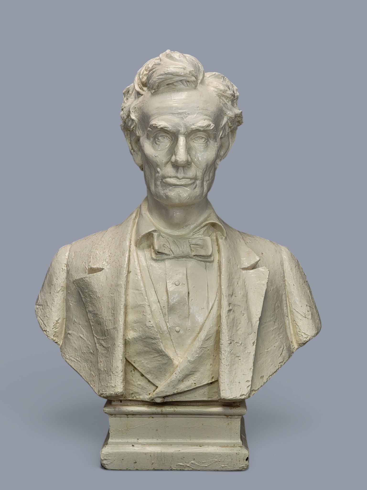 BUST OF ABRAHAM LINCOLN: American, 1st half-20th century, plaster. Possibly produced by P.P. Caproni and Brother Co., Boston, after the original bust by Max Bachmann (1862-1921). A life-sized bust of a beardless Lincoln