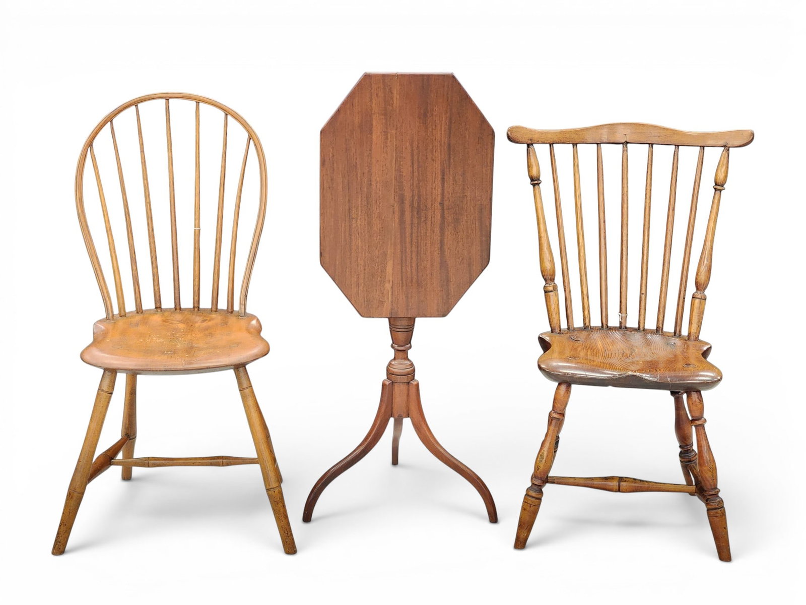 TWO WINDSORS AND A CANDLESTAND: American, early 19th century. Includes a mahogany, tilt-top candlestand with tripod base, 28" high; together with a bowback windsor, 36" high; and a fanback windsor, 34" high. Provenance: from a south