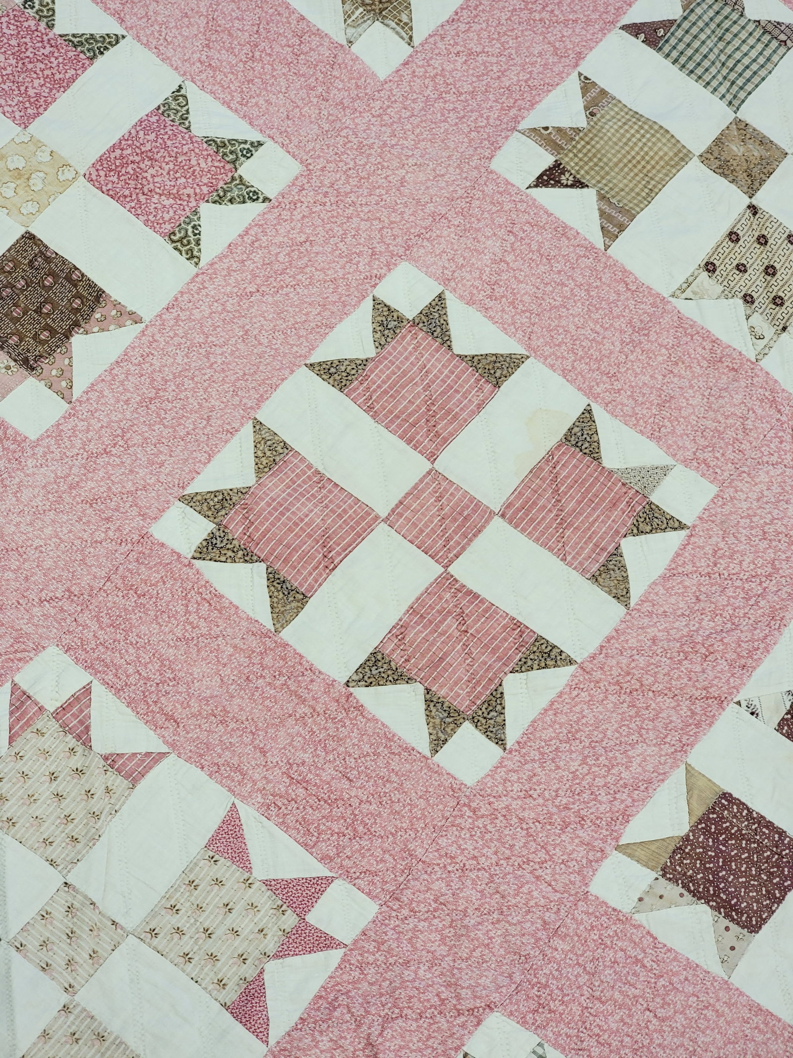 "CROSS AND CROWN' QUILT: American, c. 1900, cotton. Hand-pieced, hand-quilted, with printed fabrics. 81" by 82". Provenance: an Ohio collection. NOTE: We are happy to answer questions and take additional photos of lots prior 