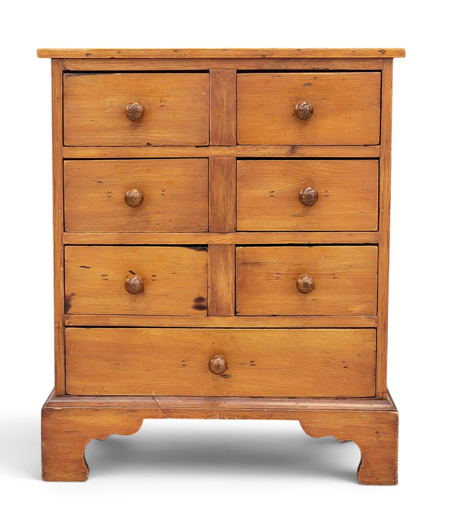 APOTHECARY OR SEED CHEST: American, 19th century, pine. Seven dovetailed drawers and bracket feet. Illegibly inscribed on the back. 30.5" high, 25" wide, 19.5" deep. Provenance: an Ohio collection. NOTE: We are happy to