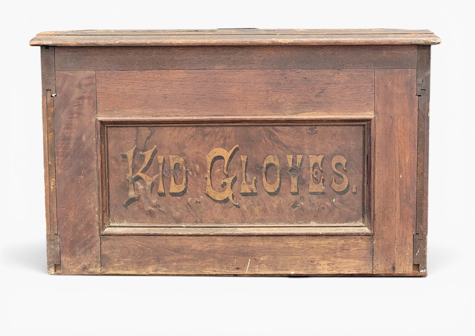 KID GLOVES COUNTER-TOP DISPLAY: Smith and Traver, New York, late 19th century, walnut and poplar. Decorated front and sides, and the back with 18 drawers with their original porcelain pulls that are marked with the sizes. 14.25"