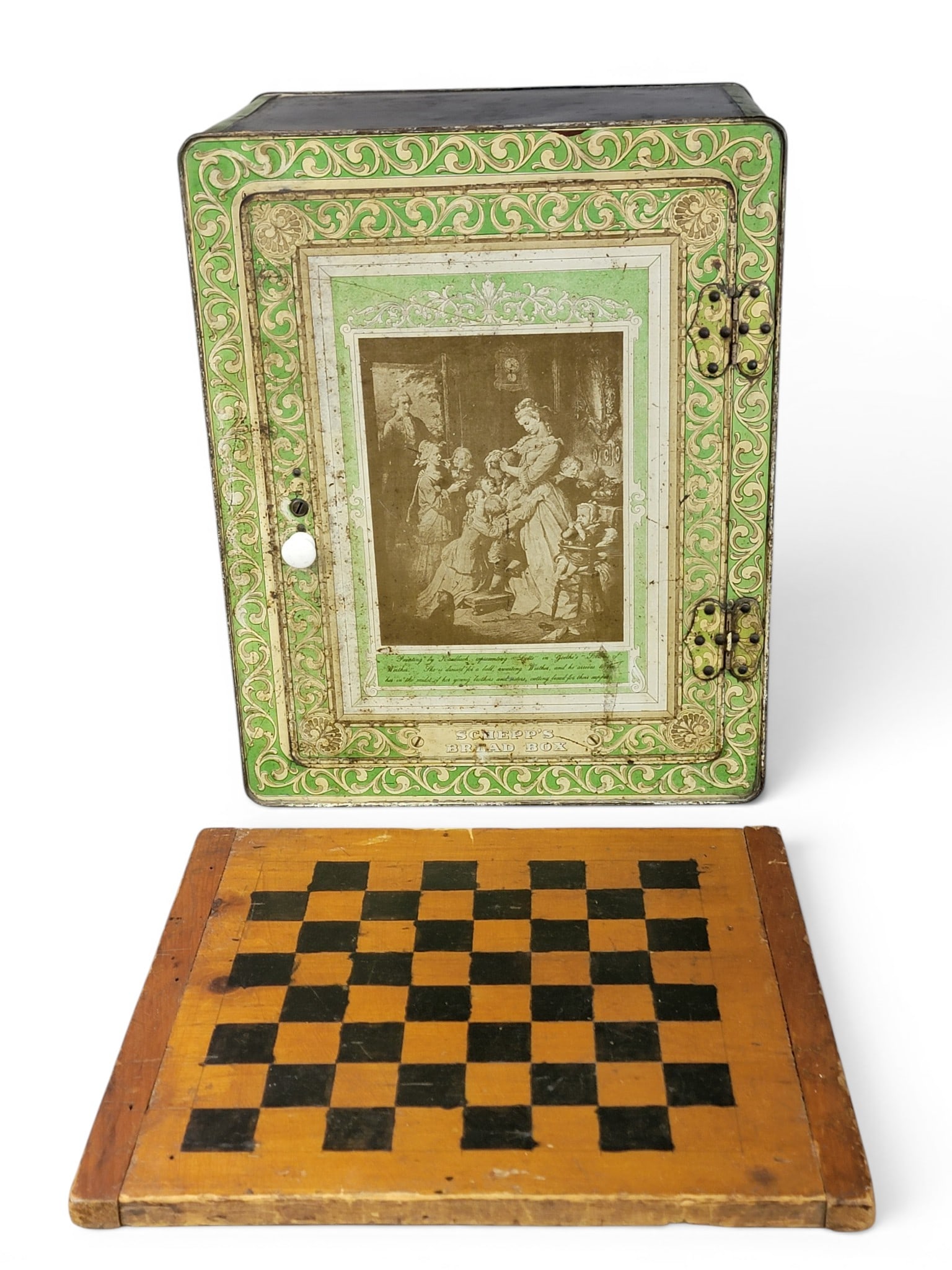 TIN BREADBOX AND GAMEBOARD: American, 19th century. Schepp's breadbox with lithographed decoration, 20" high, 15.75" wide, 10" deep; together with a painted checkerboard, 16.75" by 15.75". Provenance: an Ohio collection. NOTE: W