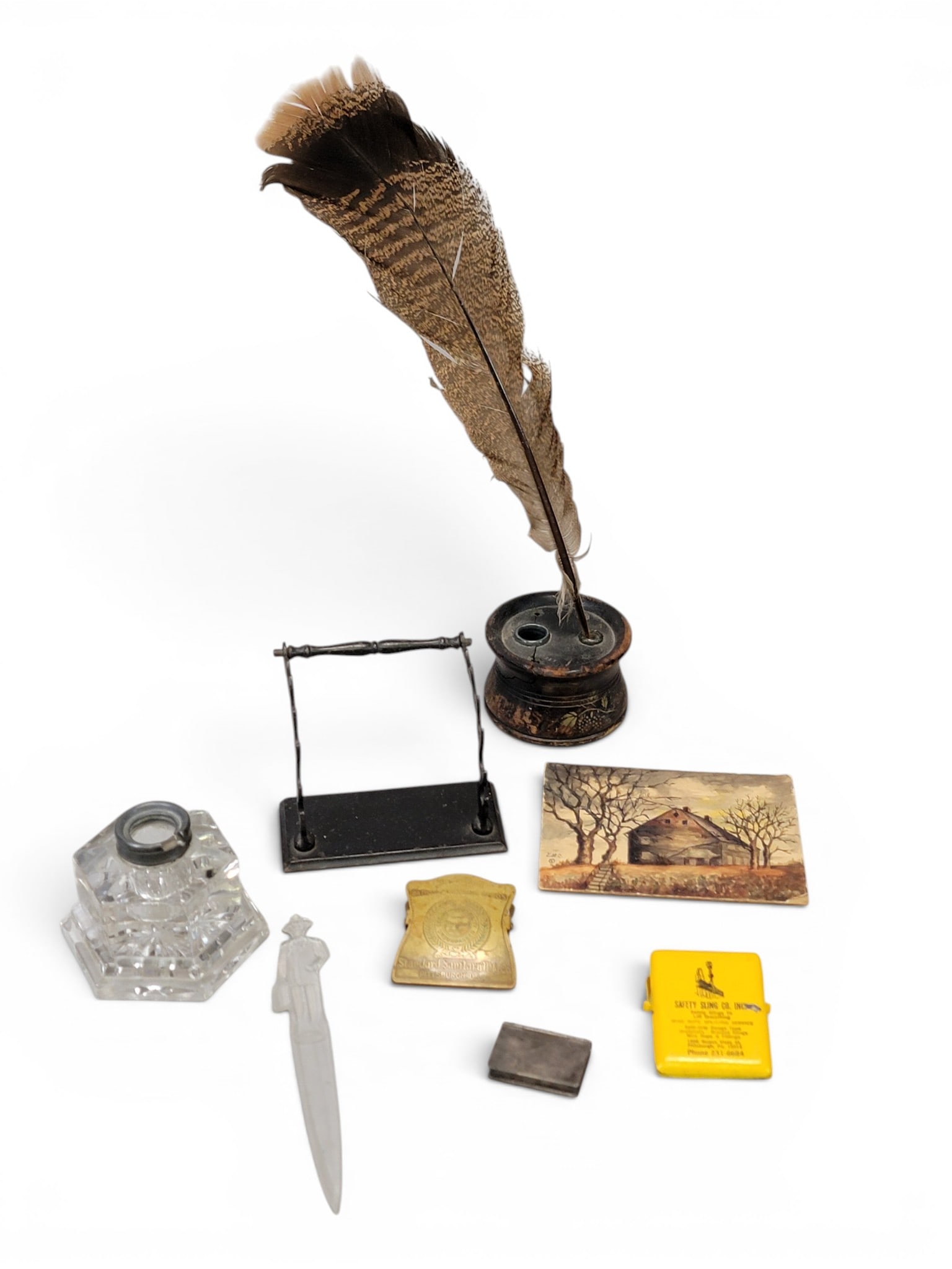 COLLECTION OF ACCESSORIES: Includes a Silliman decorated inkwell, a crystal inkwell, a cast iron pen rack, two advertising clips, a Fuller Brush letter opener, a small watercolor signed Emelie Mason Crook (dated 1925), and a st