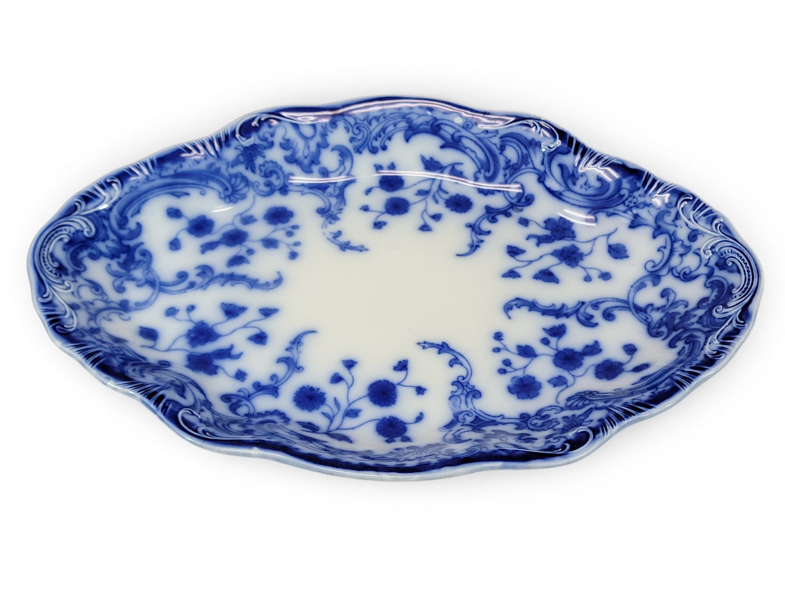 ASSEMBLED SET OF FLOW BLUE CHINA: Various makers including Grindley and Wood, 19th-20th century, mostly similar patterns. Plates, platter, serving pieces, and cups/saucers. Provenance: Collection of Bob and Maxine Edwards, New