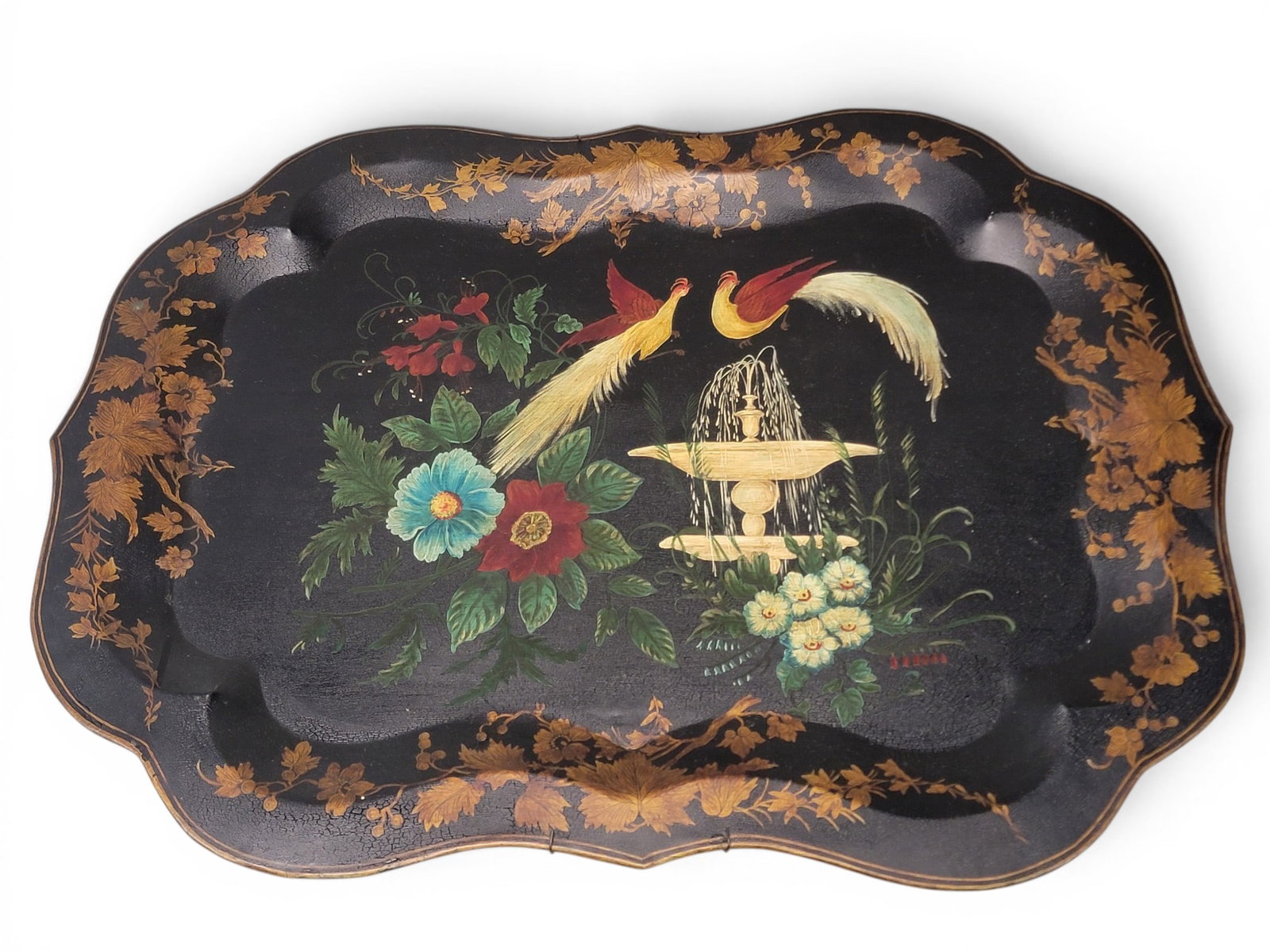 TWO TOLE-DECORATED TRAYS: Late 19th century, tin-plated iron. With original decoration: with flowers, 22.75" long; and with birds, fountain, and flowers, 29.25" long. Provenance: Collection of Bob and Maxine Edwards, New