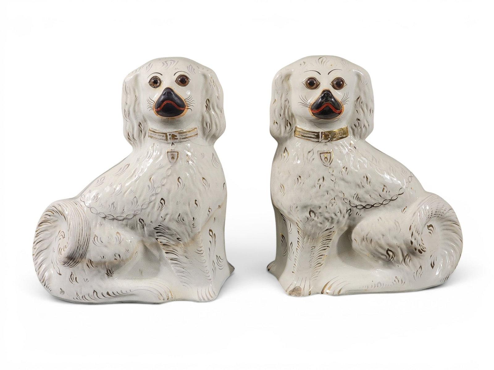 MINIATURE WAG-ON-THE-WALL CLOCK AND PAIR OF STAFFORDSHIRE SPANIELS: German and English, 19th century. The clock with landscape-painted dial, 11" high, 7.75" wide; and the dogs with simple decoration, 12.5" high. Provenance: Collection of Bob and Maxine Edwards, New