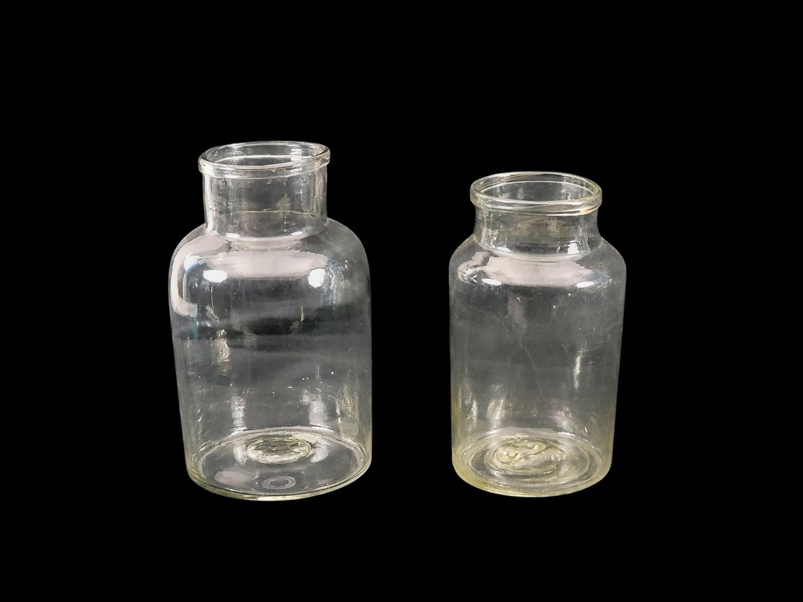 SIX PICKLING JARS: European, 20th century, glass. Of similar shape. One is 12" high, four are 10" high, and one is 9.5" high. Provenance: a Kentucky collection. NOTE: We are happy to answer questions and take additional