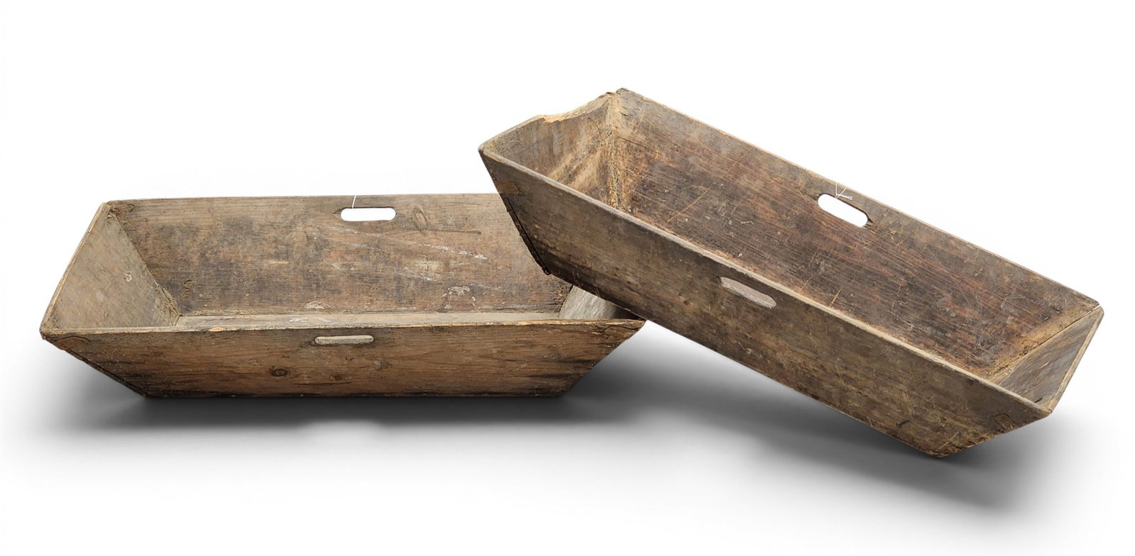 TWO LARGE HANDLED TRAYS: European, early 20th century. Canted sides and old finishes. 34.25" long each. Provenance: a Kentucky collection. NOTE: We are happy to answer questions and take additional photos of lots prior to