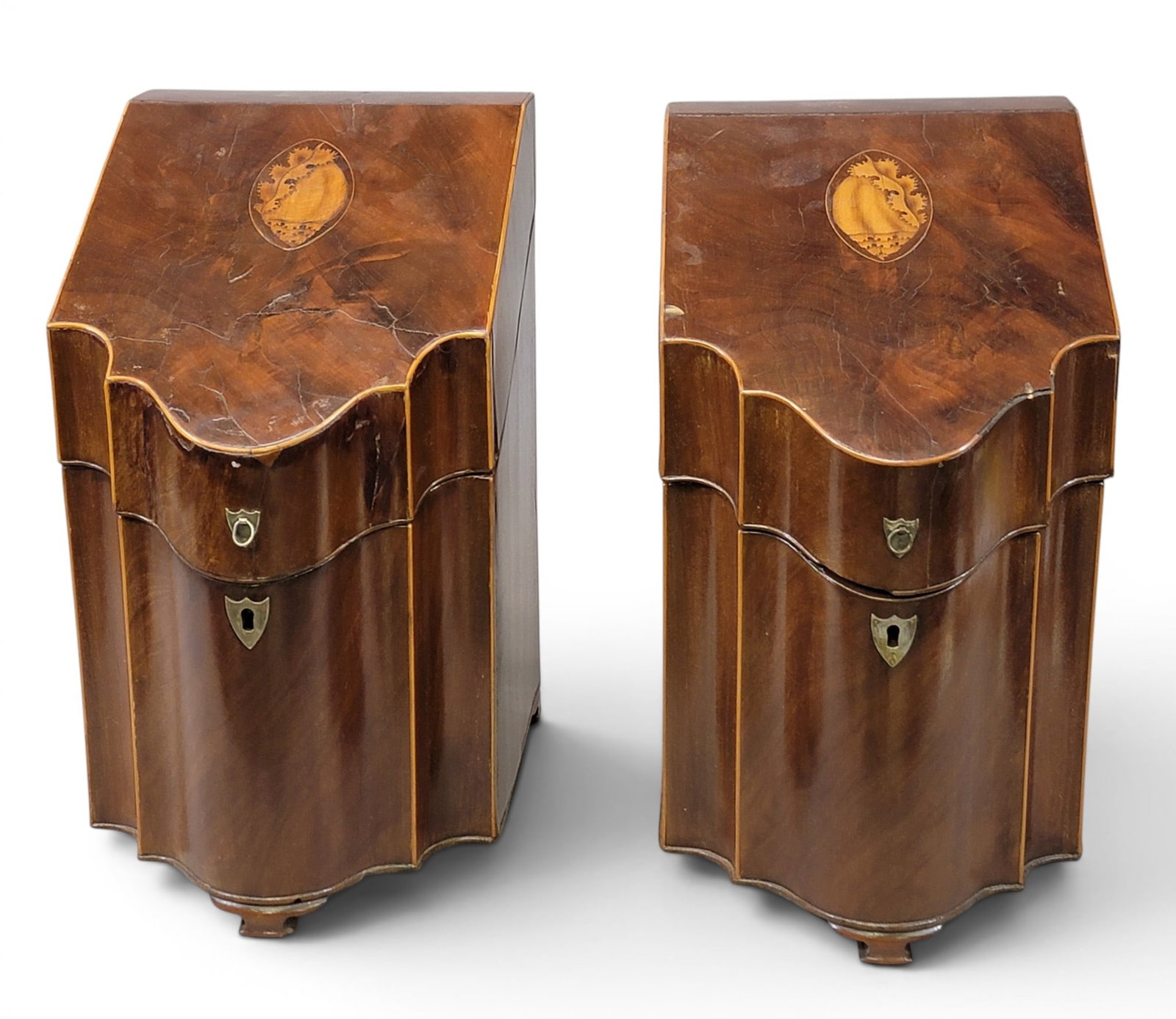 PAIR OF GEORGE III KNIFE BOXES: English, early 19th century, mahogany. Serpentine fronts with inlaid shells on the lid, and inlaid stars on the interior. 15.25" high. Provenance: a northeast Ohio collection. NOTE: We are happy to