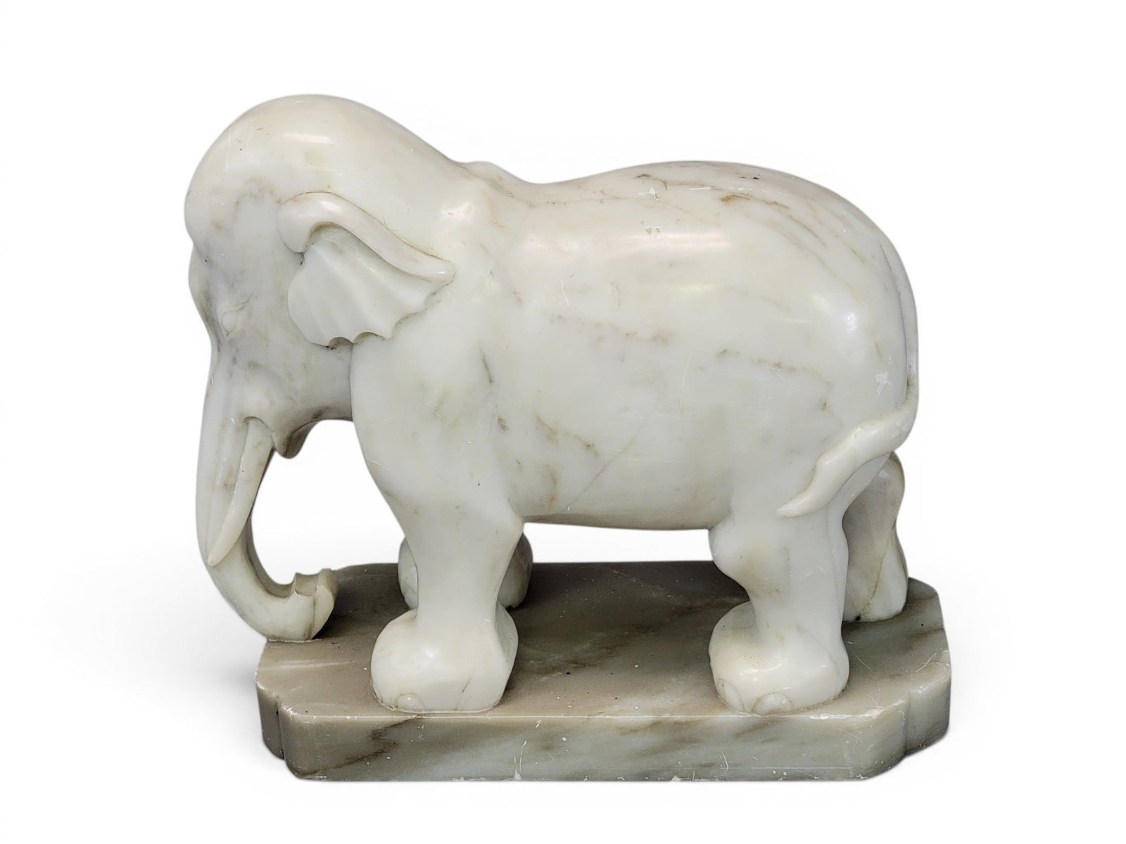 CARVED ALABASTER ELEPHANT: Late 19th-early 20th century. 9.75" high, 12" long. Provenance: a northeast Ohio collection. NOTE: We are happy to answer questions and take additional photos of lots prior to the auction (the sooner