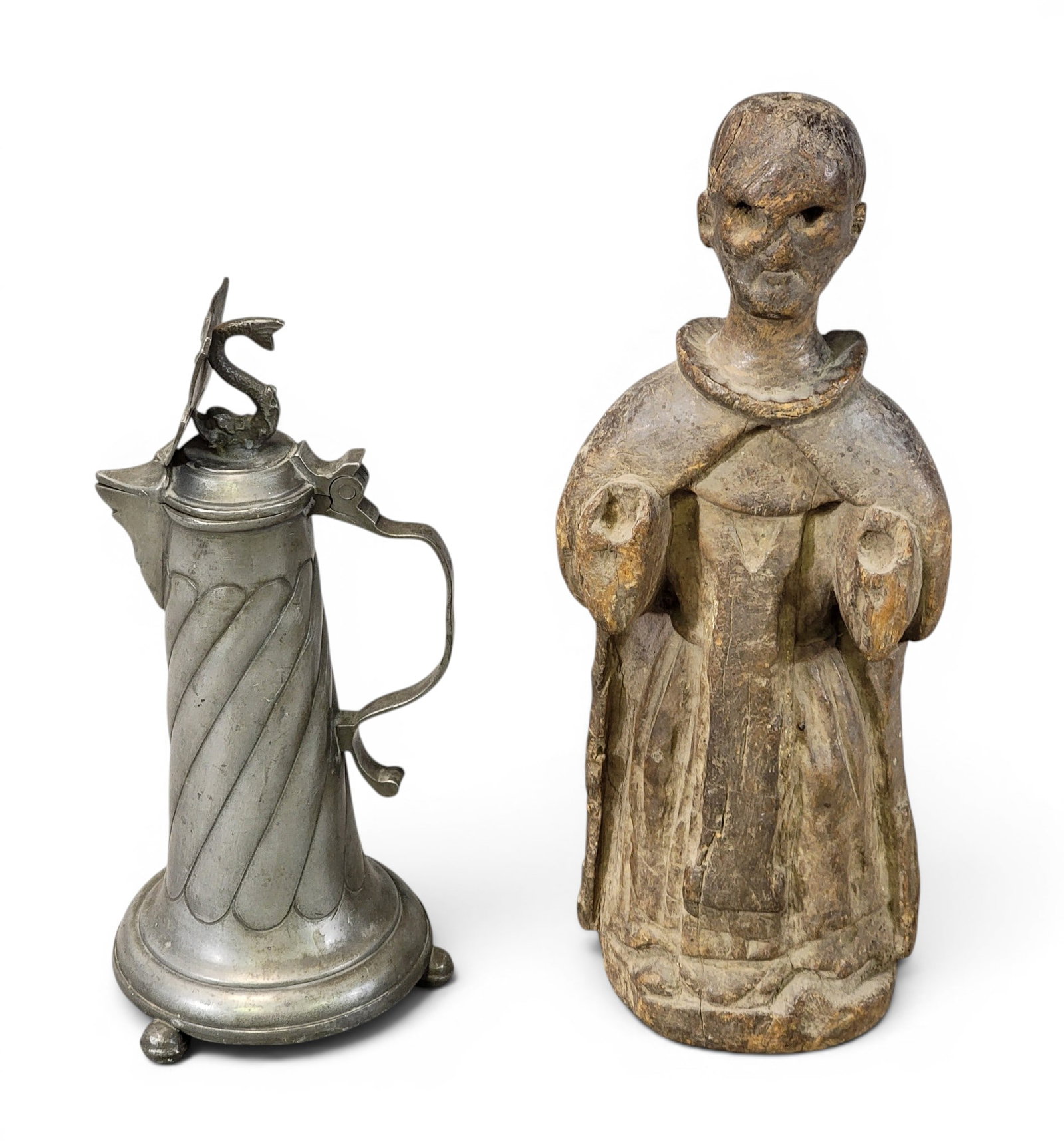 PEWTER EWER AND CARVED FIGURE: 19th century. Includes a small ewer/pitcher, probably Austro-Hungarian, 9.75" high; together with a santos-style carved figure, 11.75" high. Provenance: a northeast Ohio collection. NOTE: We are