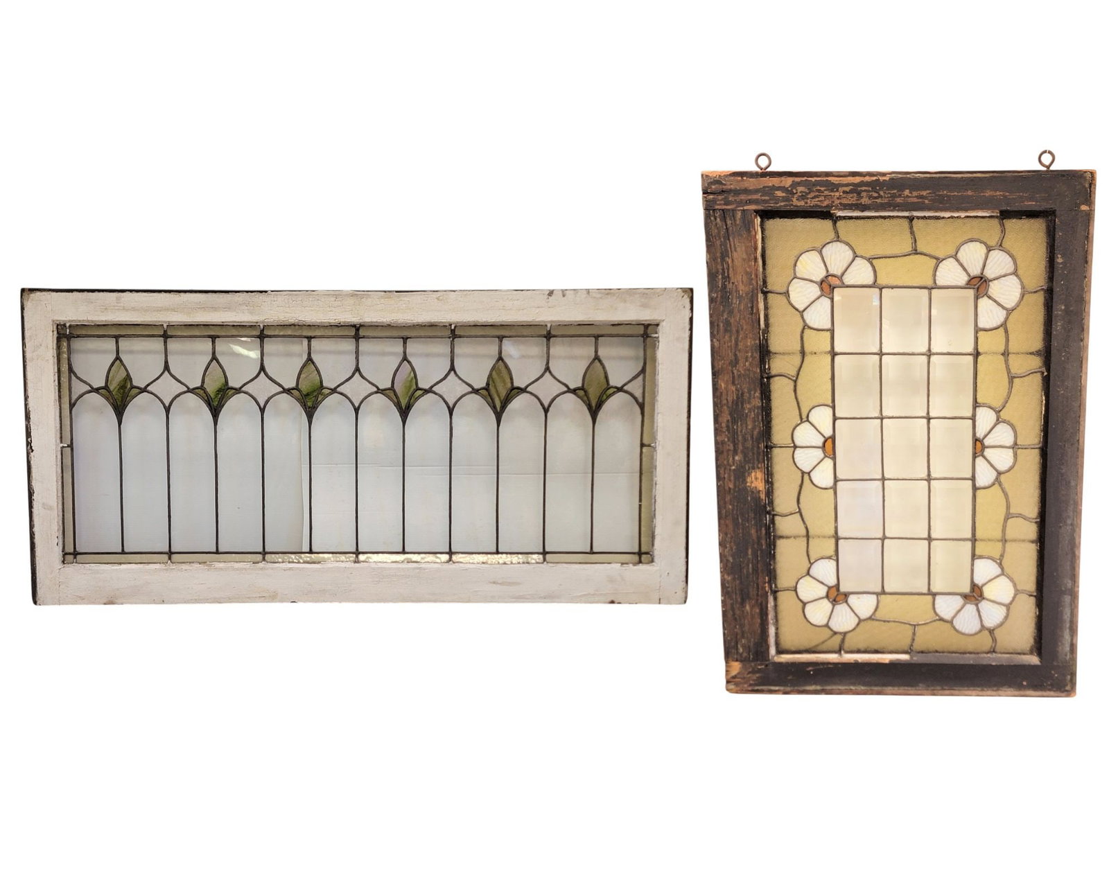 TWO ARTS & CRAFTS STAINED GLASS WINDOWS: Early 20th century. With flowers and beveled glass 30.25" high, 21.25" wide; together with tulips, 23" high, 42.5" wide. Provenance: a northeast Ohio collection. NOTE: We are happy to answer questions