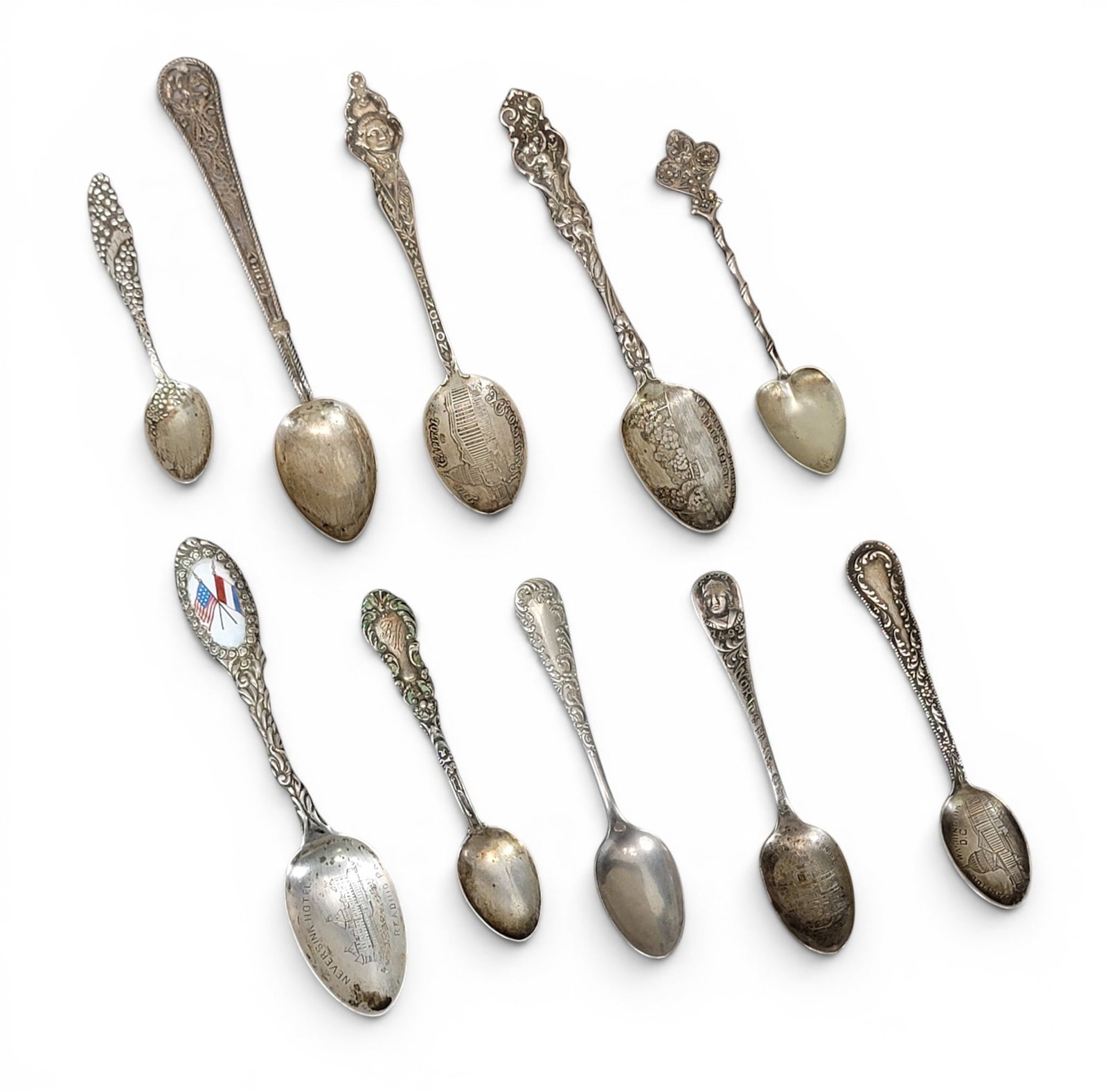 COLLECTION OF SILVER SPOONS: 20th century. Mostly sterling and souvenir spoons, including Washington DC and Neversink Hotel in Reading, PA (with enamel decoration). Total weight of sterling: approx. 84g. Provenance: an Ohio colle