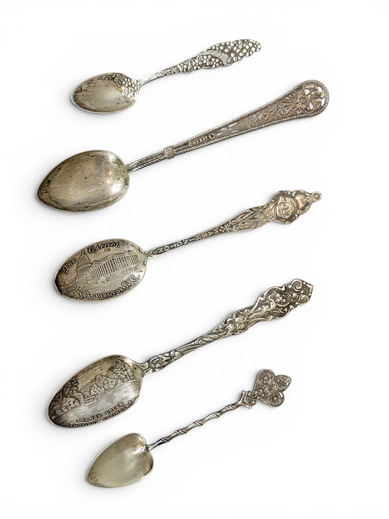 COLLECTION OF SILVER SPOONS: 20th century. Mostly sterling and souvenir spoons, including Washington DC and Neversink Hotel in Reading, PA (with enamel decoration). Total weight of sterling: approx. 84g. Provenance: an Ohio colle