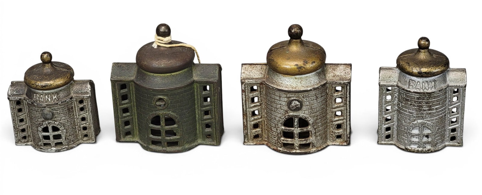 FOUR CAST IRON PRESTO BANKS: Including AC Williams and perhaps Kenton. Moore 1167, 1168, and 1169. Provenance: a northeast Ohio collection. NOTE: We are happy to answer questions and take additional photos of lots prior to the au