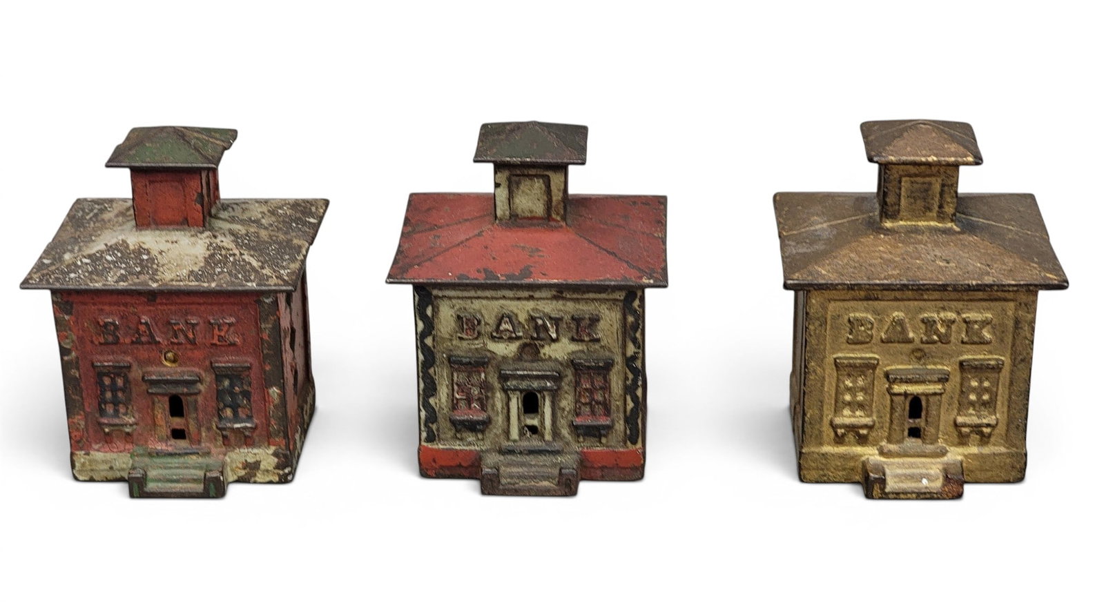 THREE J&E STEVENS CUPOLA BANKS: Moore 1147, including one with mica decorated roof. Provenance: a northeast Ohio collection. NOTE: We are happy to answer questions and take additional photos of lots prior to the auction (the sooner 