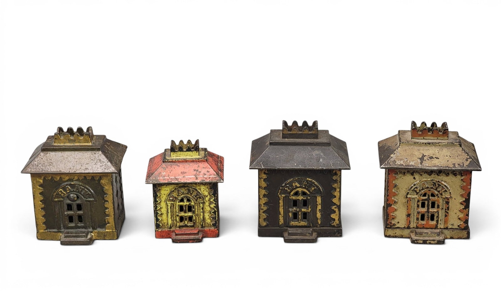 FOUR CAST IRON CROWN BUILDING BANKS: Grey Iron Casting (Moore 1226 and 1227). Provenance: a northeast Ohio collection. NOTE: We are happy to answer questions and take additional photos of lots prior to the auction (the sooner submitted t