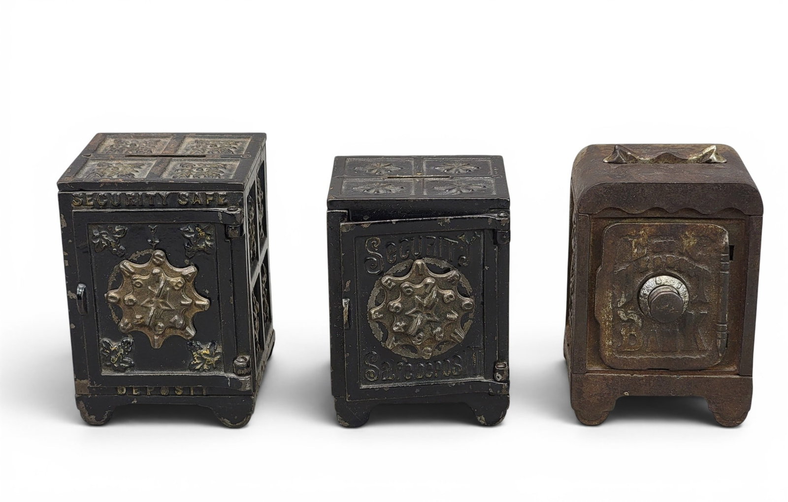 THREE CAST IRON SAFE BANKS: Includest wo Kyser and Rex(?) Security Safe Deposit (Moore 891, one varies in size);Grey Iron Casting (Moore, catalog, p. 31, no. 250). Provenance: a northeast Ohio collection. NOTE: We are happy to a