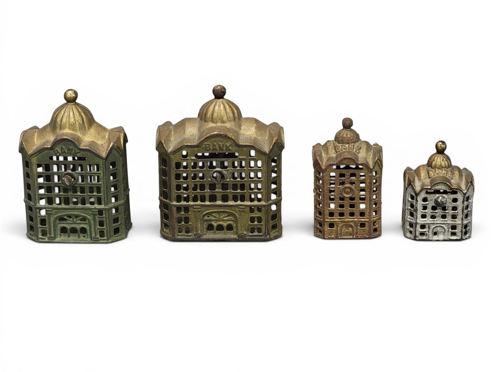 FOUR CAST IRON DOMED BANKS: AC Williams. Includes a variations (Moore 1180-1183). Provenance: a northeast Ohio collection. NOTE: We are happy to answer questions and take additional photos of lots prior to the auction (the soone
