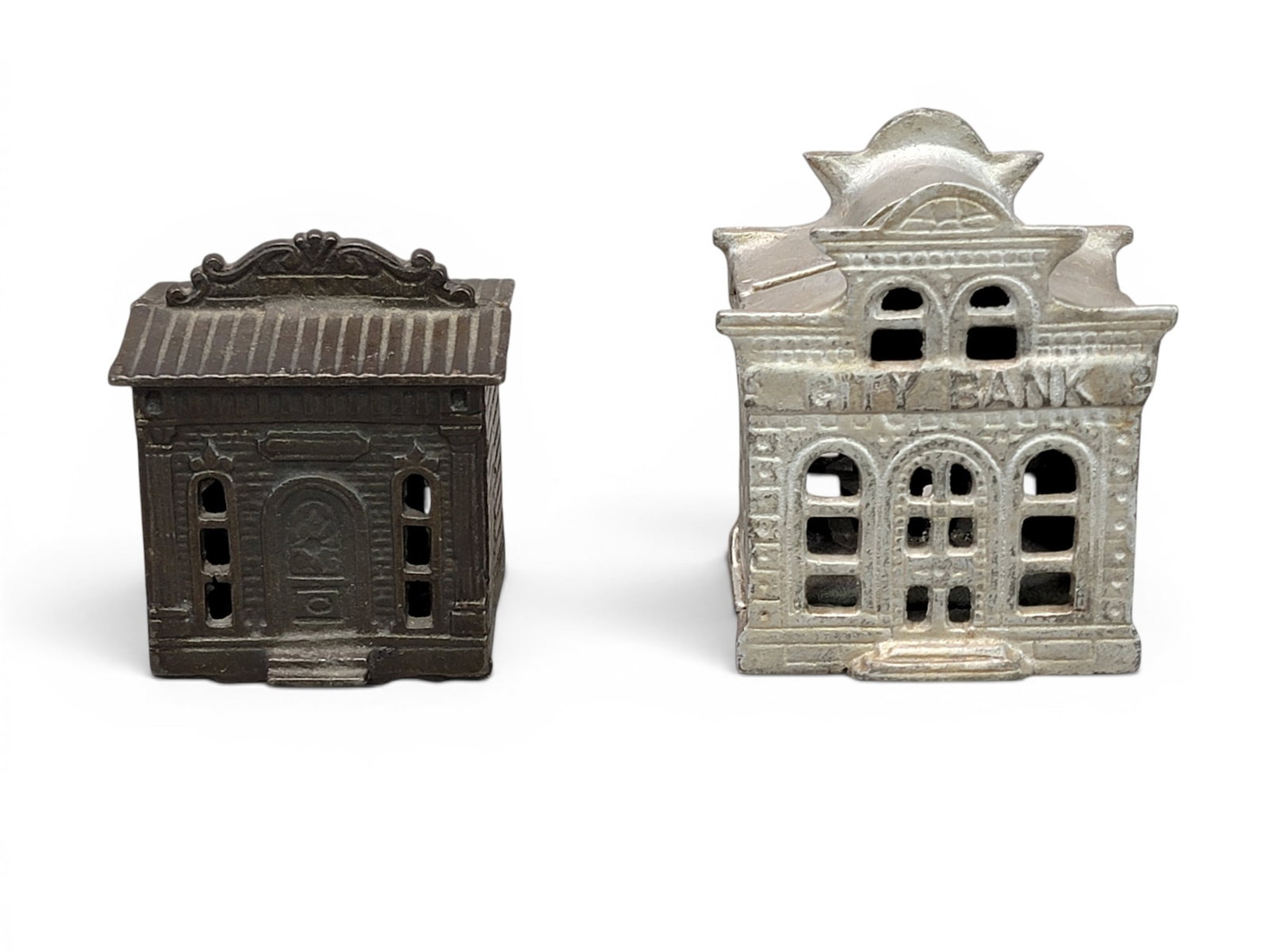 TWO CAST IRON BUILDING BANKS: Includes Judd 1876 Bank (Moore 1011); together with John Harper or Chamberlain and Hill City Bank with Director's Room on Top (Moore 1111). Provenance: a northeast Ohio collection. NOTE: We are happy 