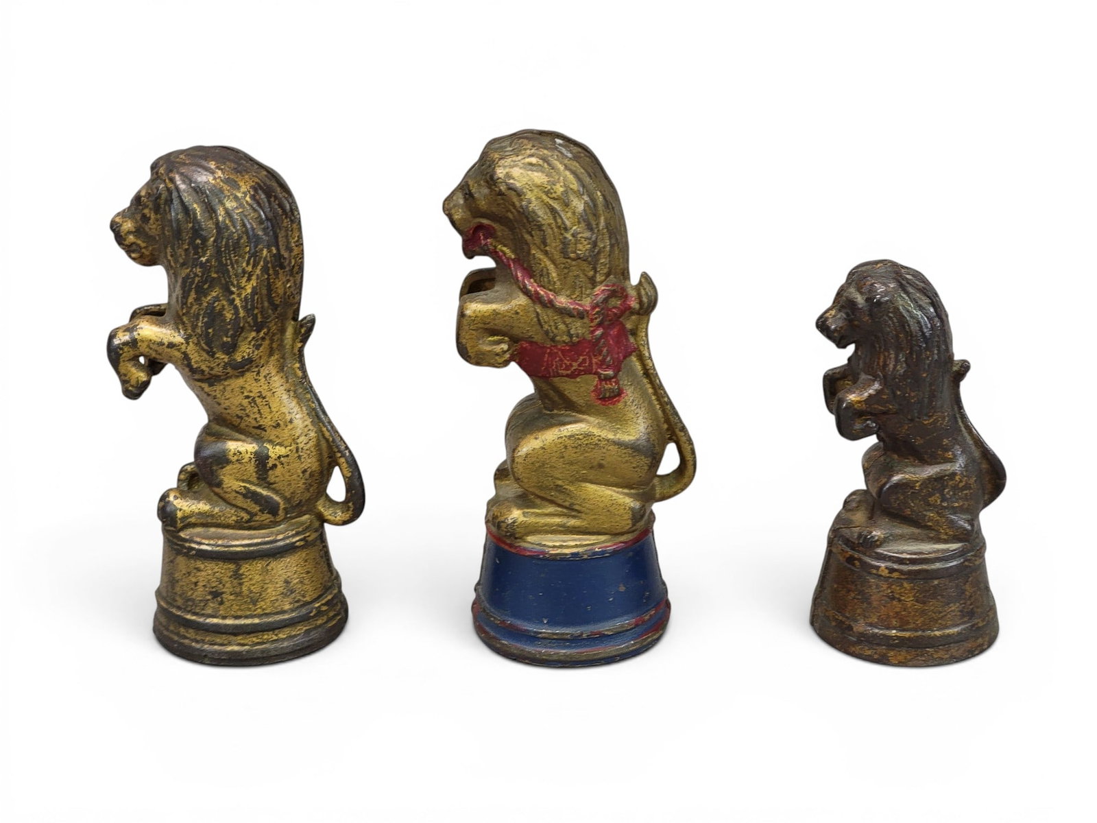 THREE CAST IRON LION BANKS: All AC Williams Lions on Tubs. Includes decorated (Moore746); Small (Moore 747); and Plain variant height, 5.5" (Moore 753). Provenance: a northeast Ohio collection. NOTE: We are happy to answer quest
