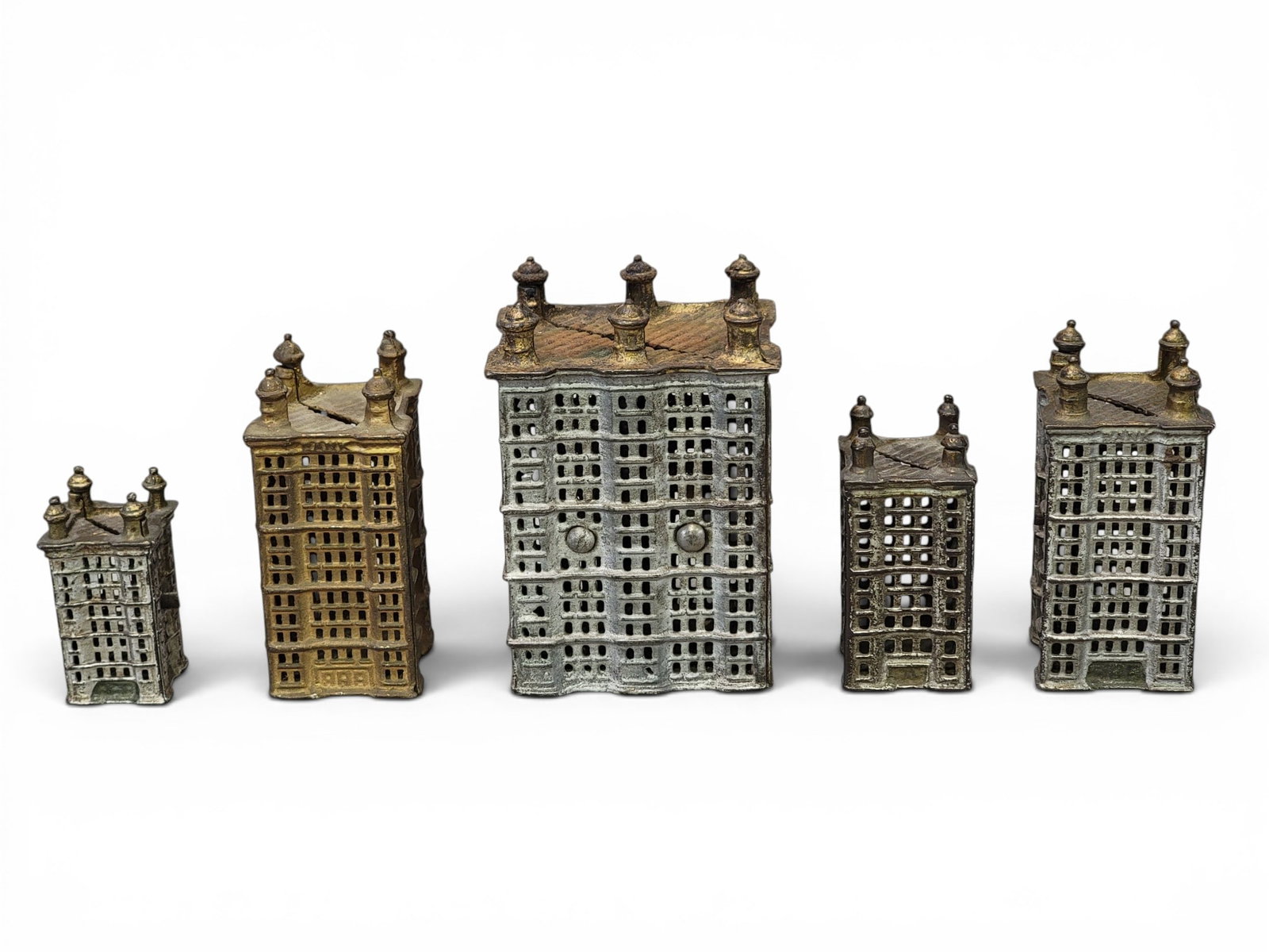 FIVE AC WILLIAMS CAST IRON BUILDING BANKS: All Skyscrapers, including one with six ports (Moore 1238-1241). Provenance: a northeast Ohio collection. NOTE: We are happy to answer questions and take additional photos of lots prior to the auction