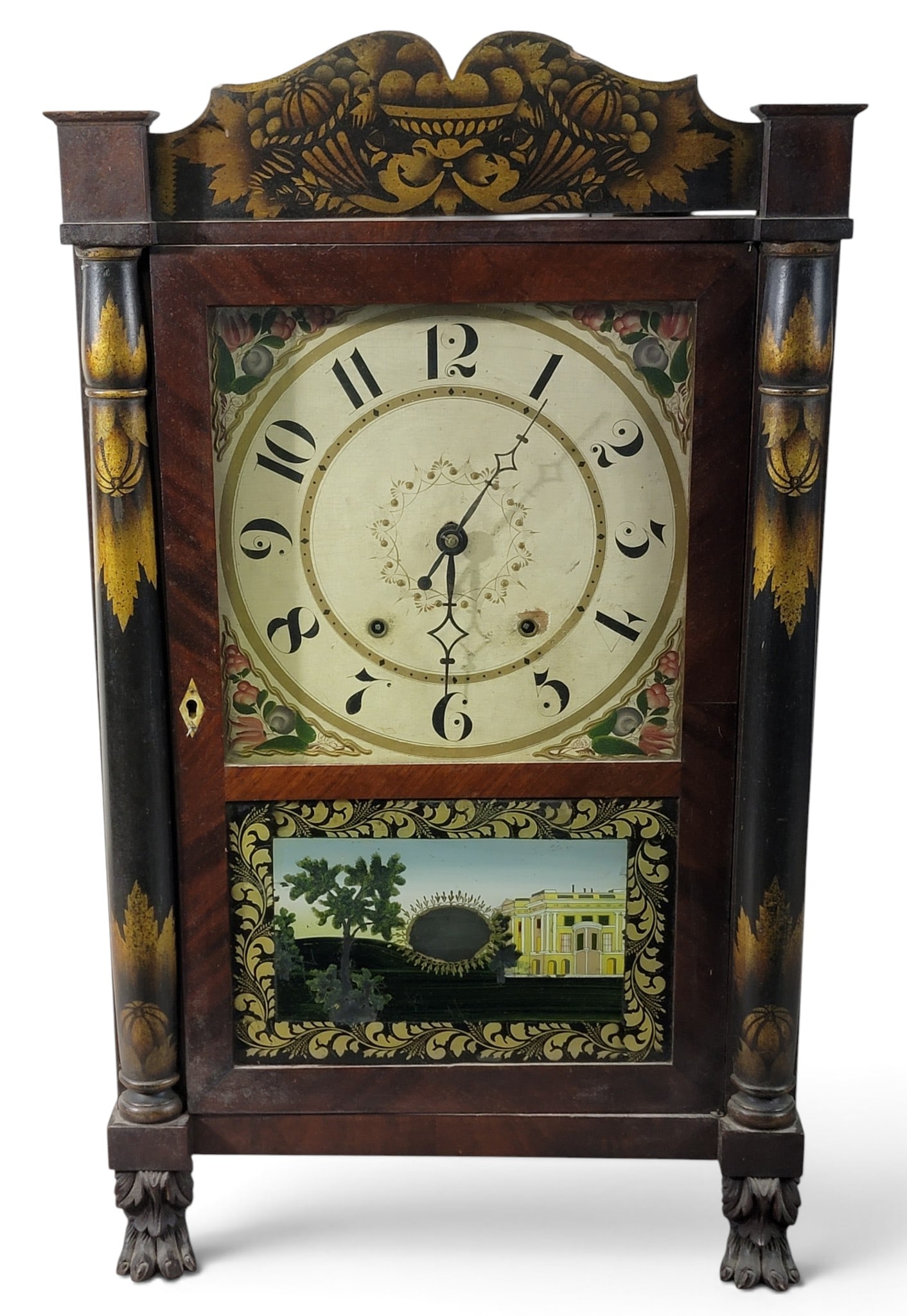 SETH THOMAS SHELF CLOCK: Connecticut, 1825-1840, mahogany. With original black and gold stenciled crest and columns, paw feet, and reverse-painted tablet. 29" high, 17.25" wide, 5" deep. Provenance: an Ohio collection. NOTE: