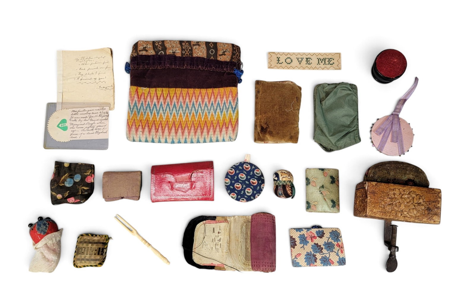 COLLECTION OF SEWING ACCOUTREMENTS: 19th century. Includes pin cushions, "housewifes," a flamestitch bag, and a wood and composition sewing bird with slide-lid pin box/pin cushion. Bag is 7" by 6.5". Provenance: an Ohio collection.