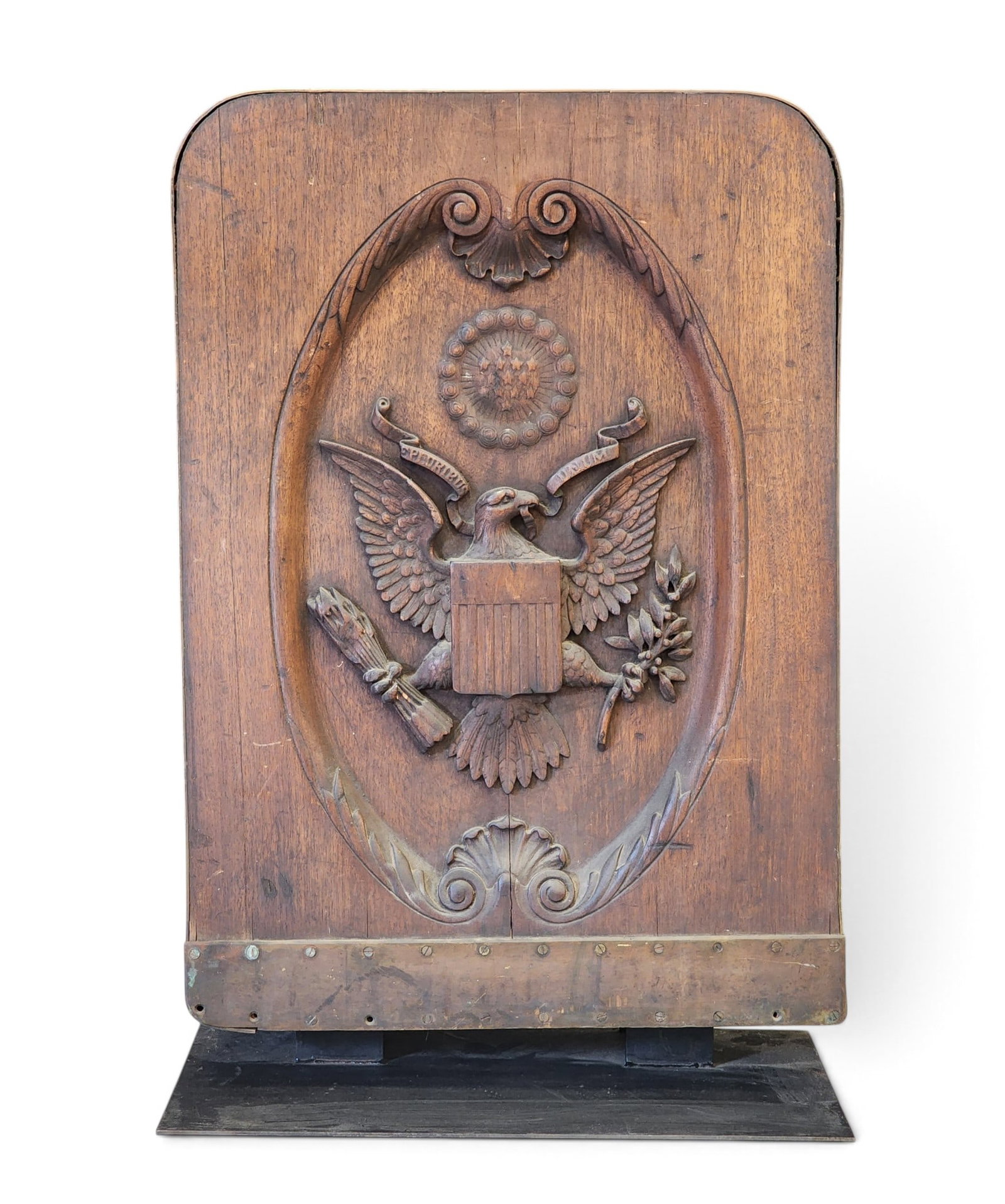 AMERICAN EAGLE-CARVED GANGWAY BOARD: American, 2nd half-19th century, mahogany and brass. Deep relief-carved shield-breasted American eagle, with arrows and an olive branch in its claws, under a circle with 13 stars, and in a surround
