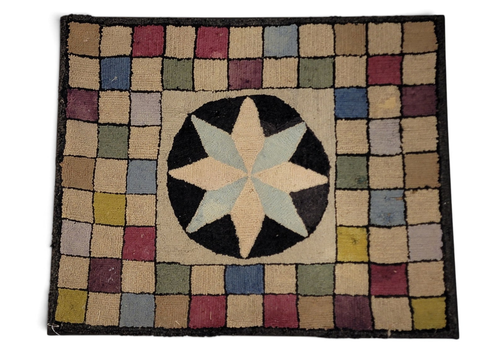 HOOKED RUG WITH STAR: American, early 20th century. Eight-pointed star against a colorful checked background. Professionally mounted for hanging. 38.25" high, 47" wide. Provenance: a southeast Pennsylvania collection. NOTE