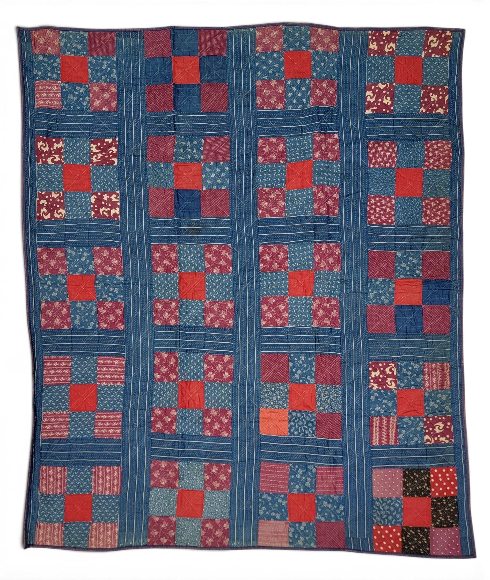 NINE-PATCH QUILT: American, 19th century blocks. Printed reds and blues, remade from an earlier quilt, using other period materials. 65" by 54". Provenance: an Ohio collection. NOTE: We are happy to answer questions