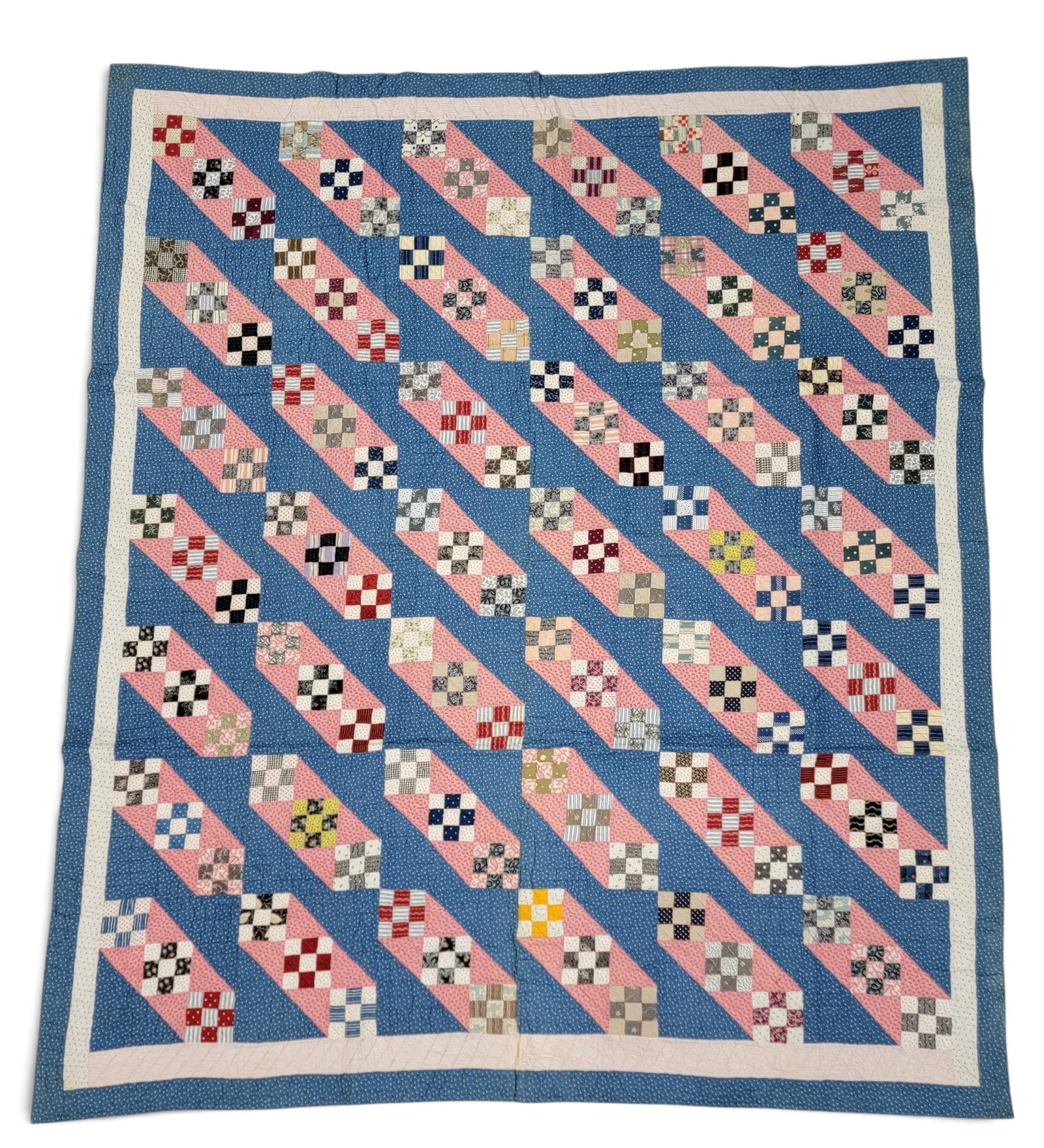 NINE-PATCH VARIANT QUILT: American, 2nd half-19th century. Triptychs of nine-patch squares against a blue ground, all printed fabrics, and the back plain cotton. 87" by 73". Provenance: an Ohio collection. NOTE: We are happy
